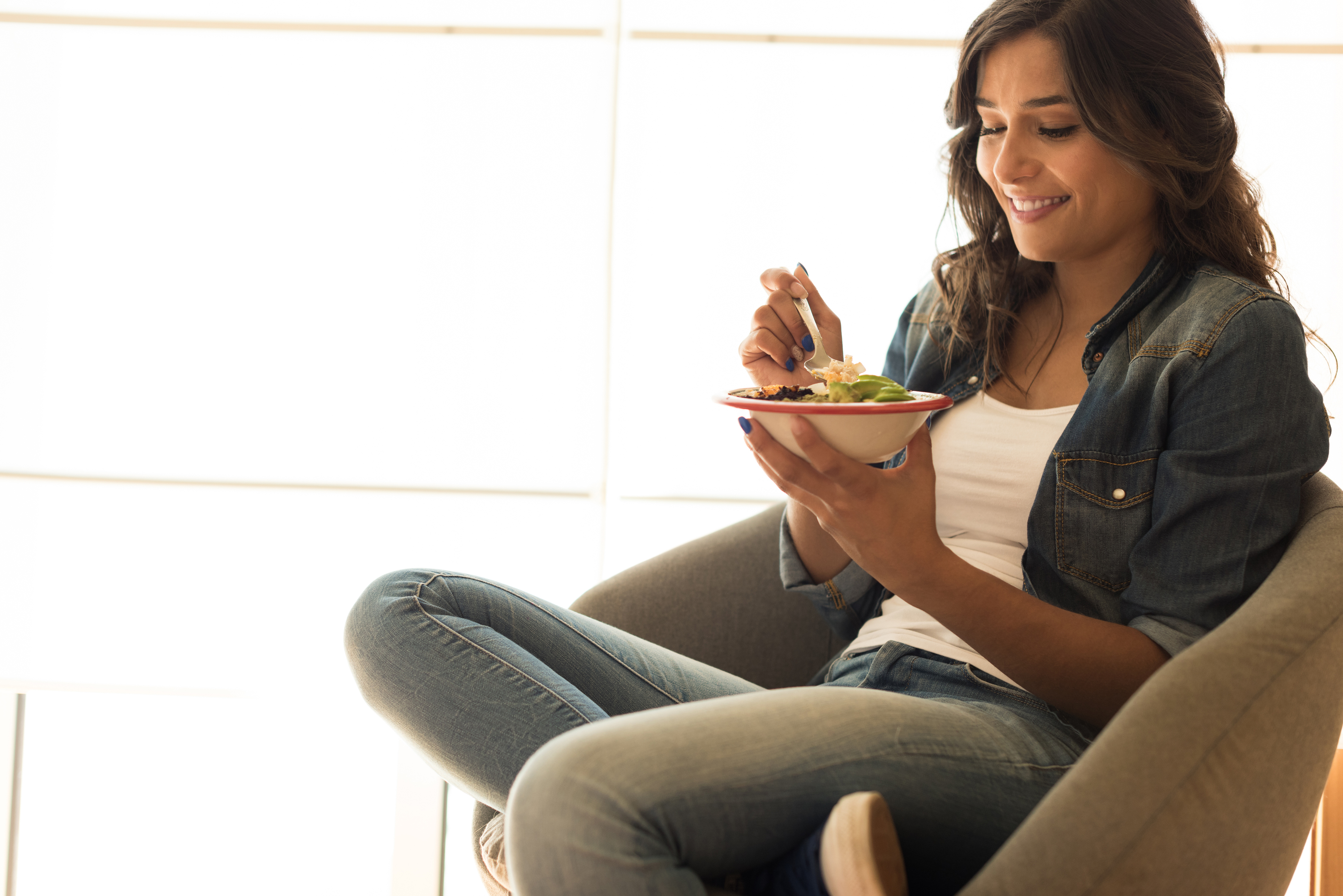 Woman eating a vegan bowl of superfoods