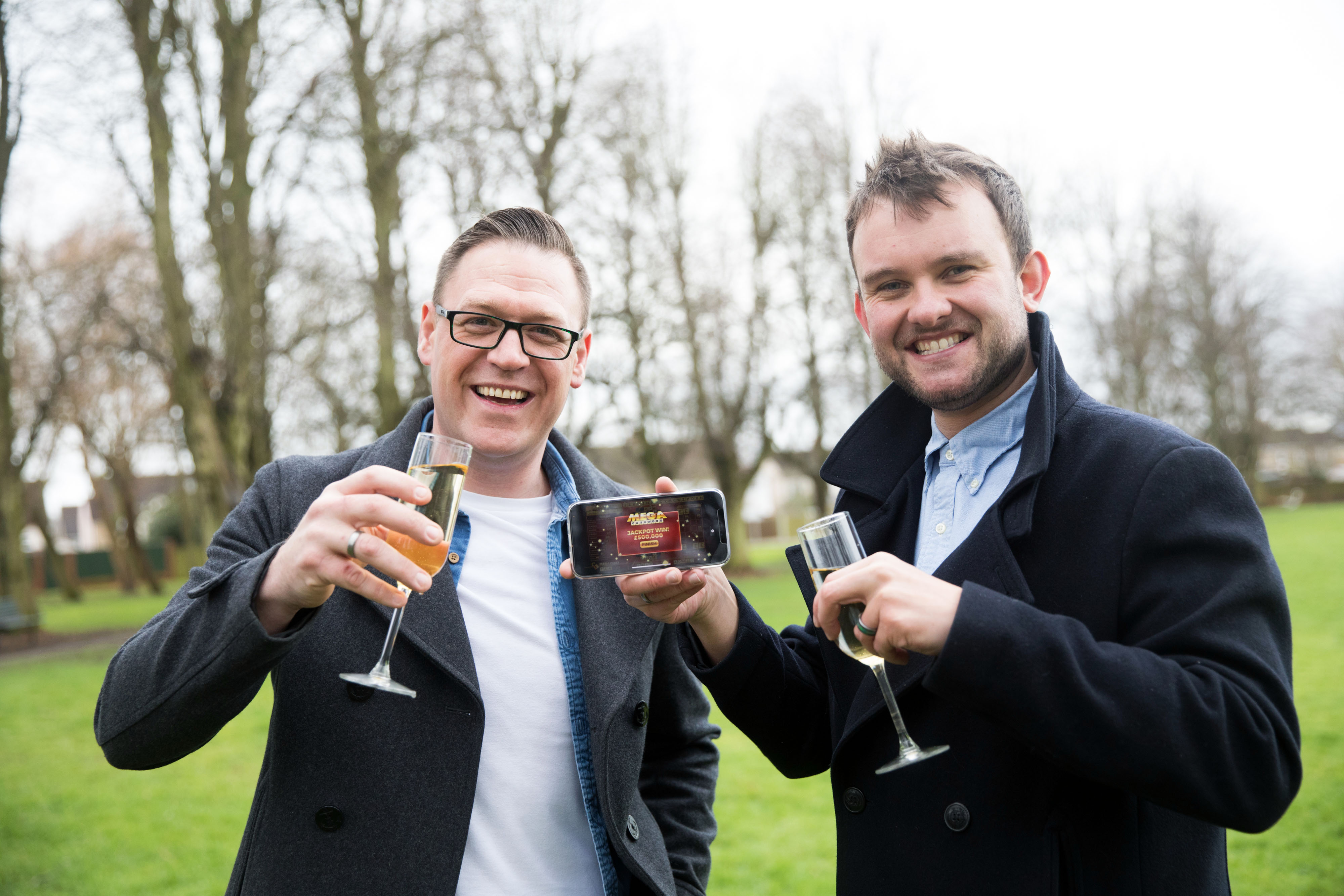 Gareth Bradley (left) won £500,000 on the National Lottery game Mega Cashword, and celebrated with his partner Connor Dennis. (National Lottery/ PA)