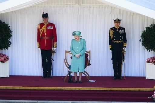 Sir Anthony Johnstone-Burt stands behind the Queen in the dark uniform (Joanne Davidson/PA)