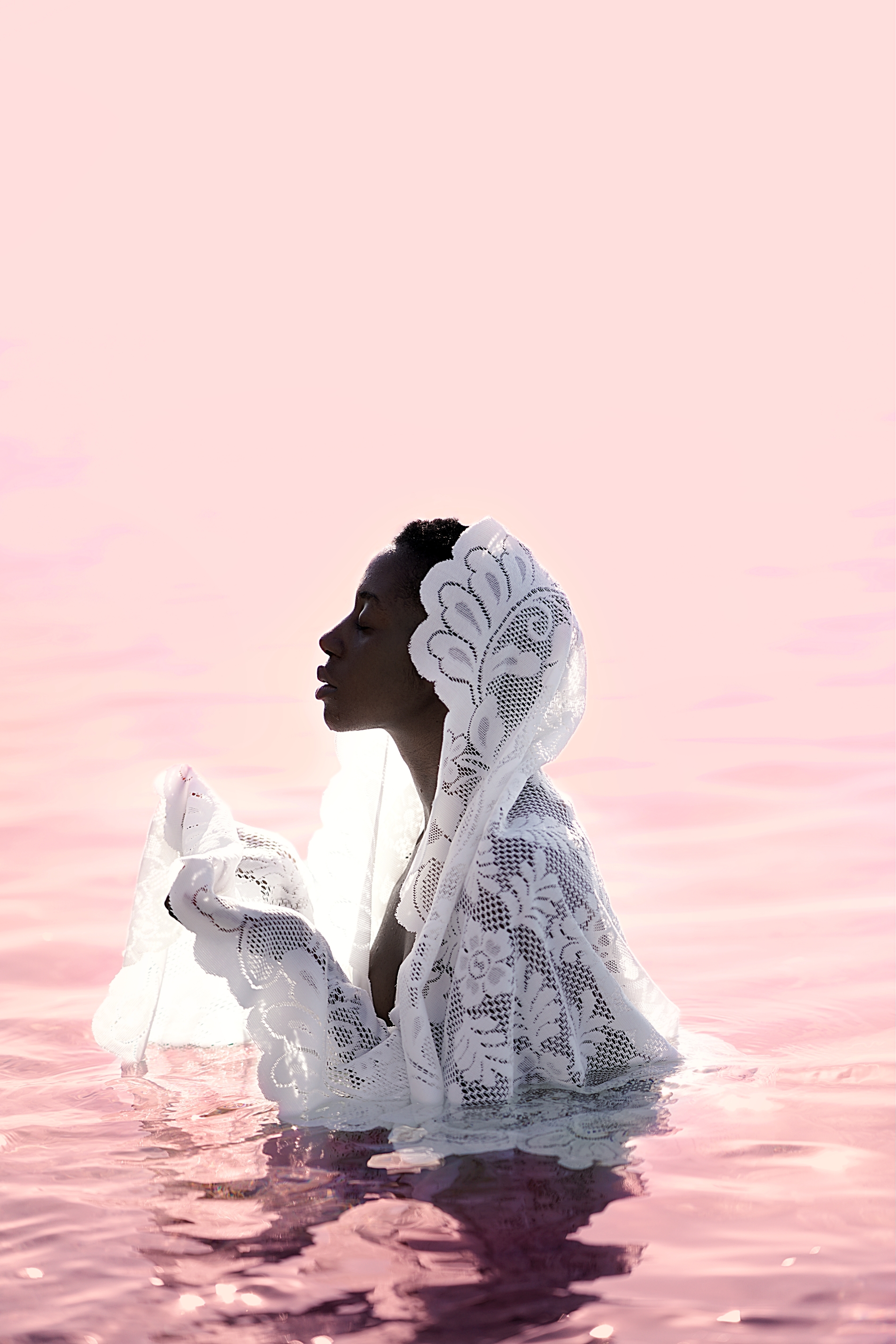 A woman stood in pink water