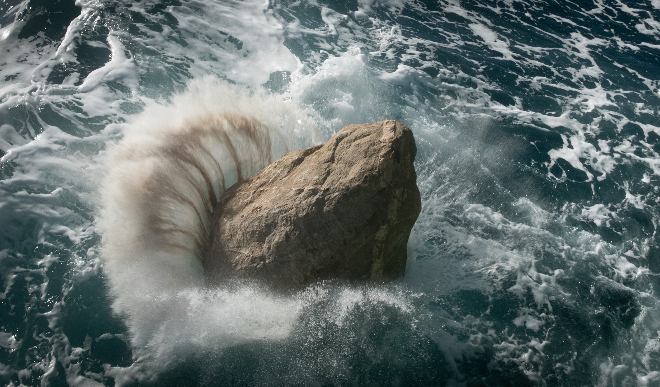 A boulder falls into the English channel from Greenpeace vessel Esperanza (Suzanne Plunkett/Greenpeace/PA)