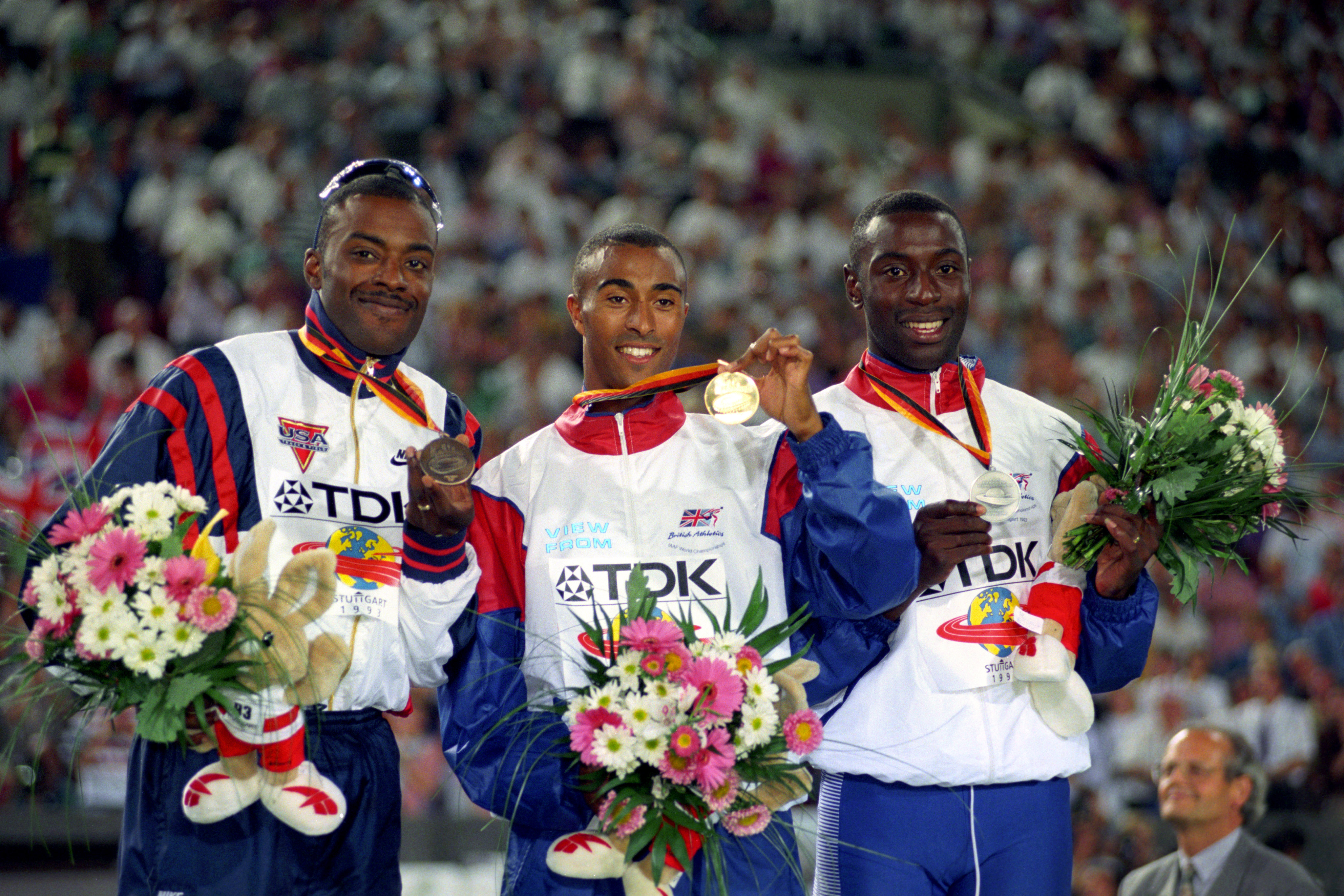 Colin Jackson (centre) after winning gold at the 1993 World Championships Men's 100m Hurdles (PA)