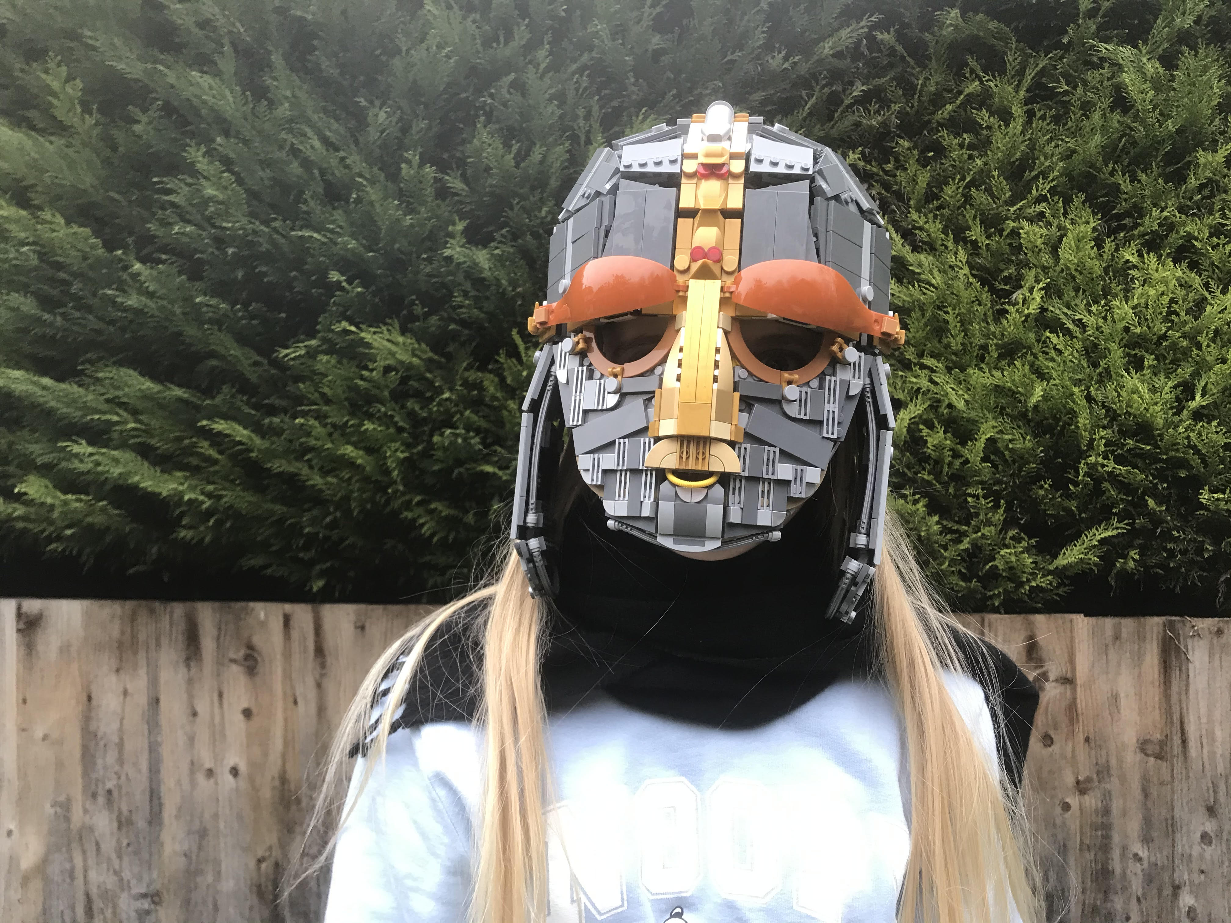 Matilda Webb, 11, wears the replica of the Sutton Hoo helmet. (Andrew Webb/ PA)