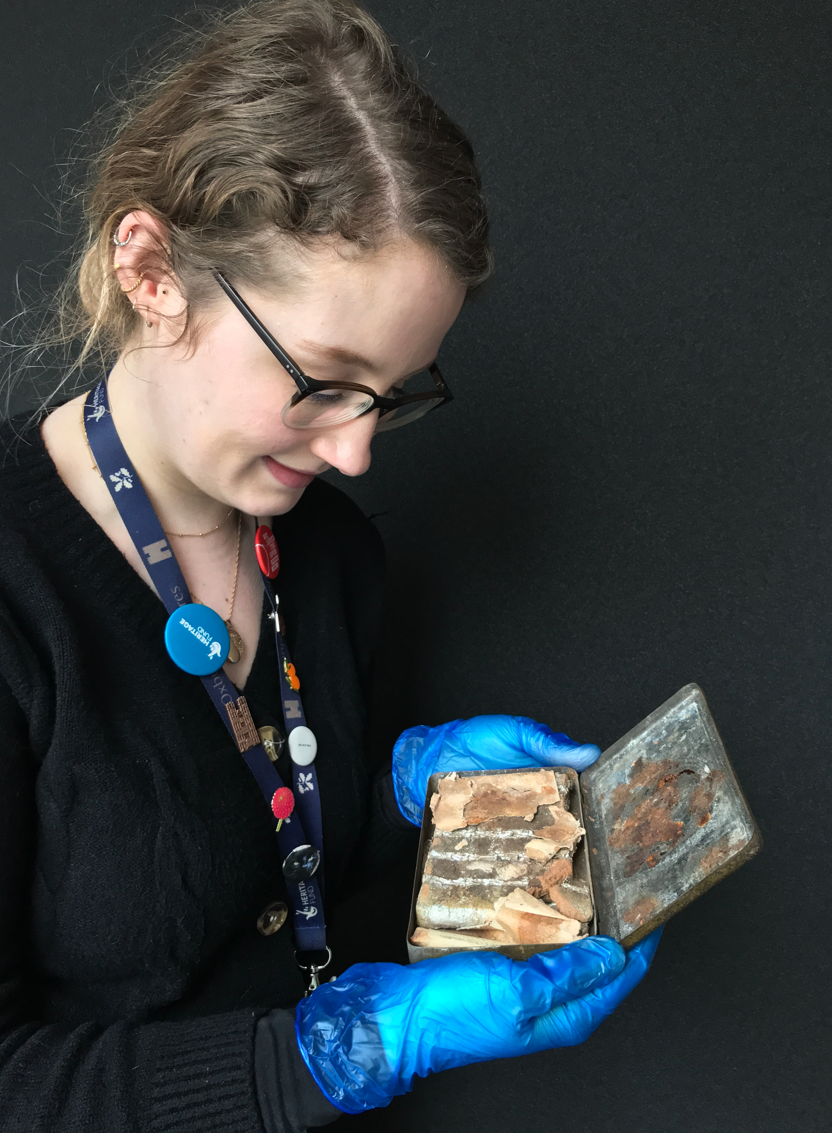 Katherine Bridges, Senior House and Collections Officer, reveals what's inside the tin at Oxburgh Hall (National Trust/ Victoria McKeown/ PA)