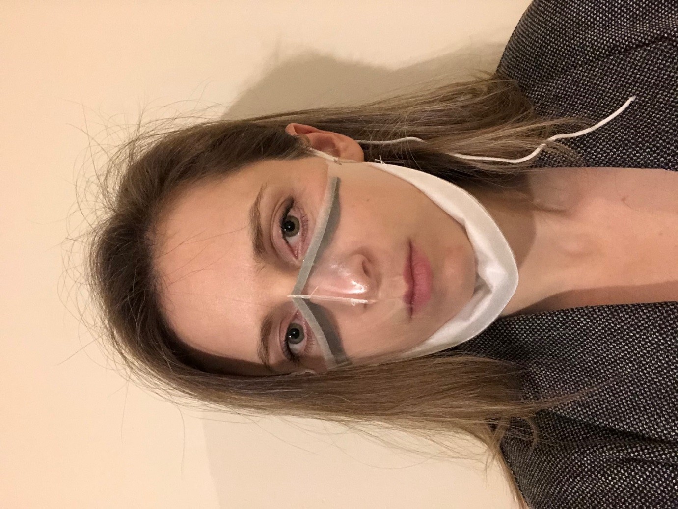 Design and innovation engineer Abi Bush demonstrates the new see-through mask. (Cambridge University Hospitals/ PA)