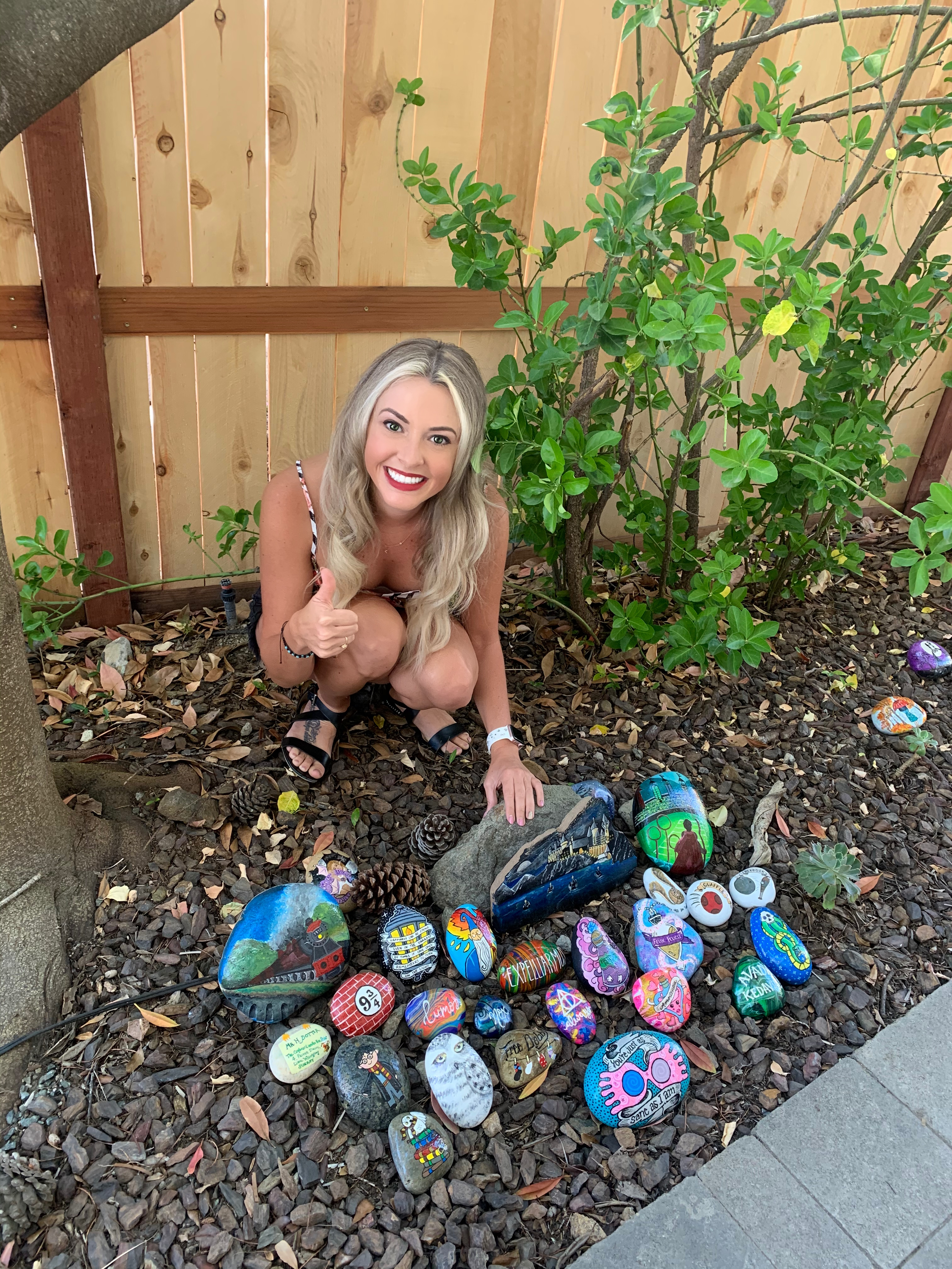 Kristen Newman and her Harry Potter rock garden, with stones painted in a Harry Potter theme