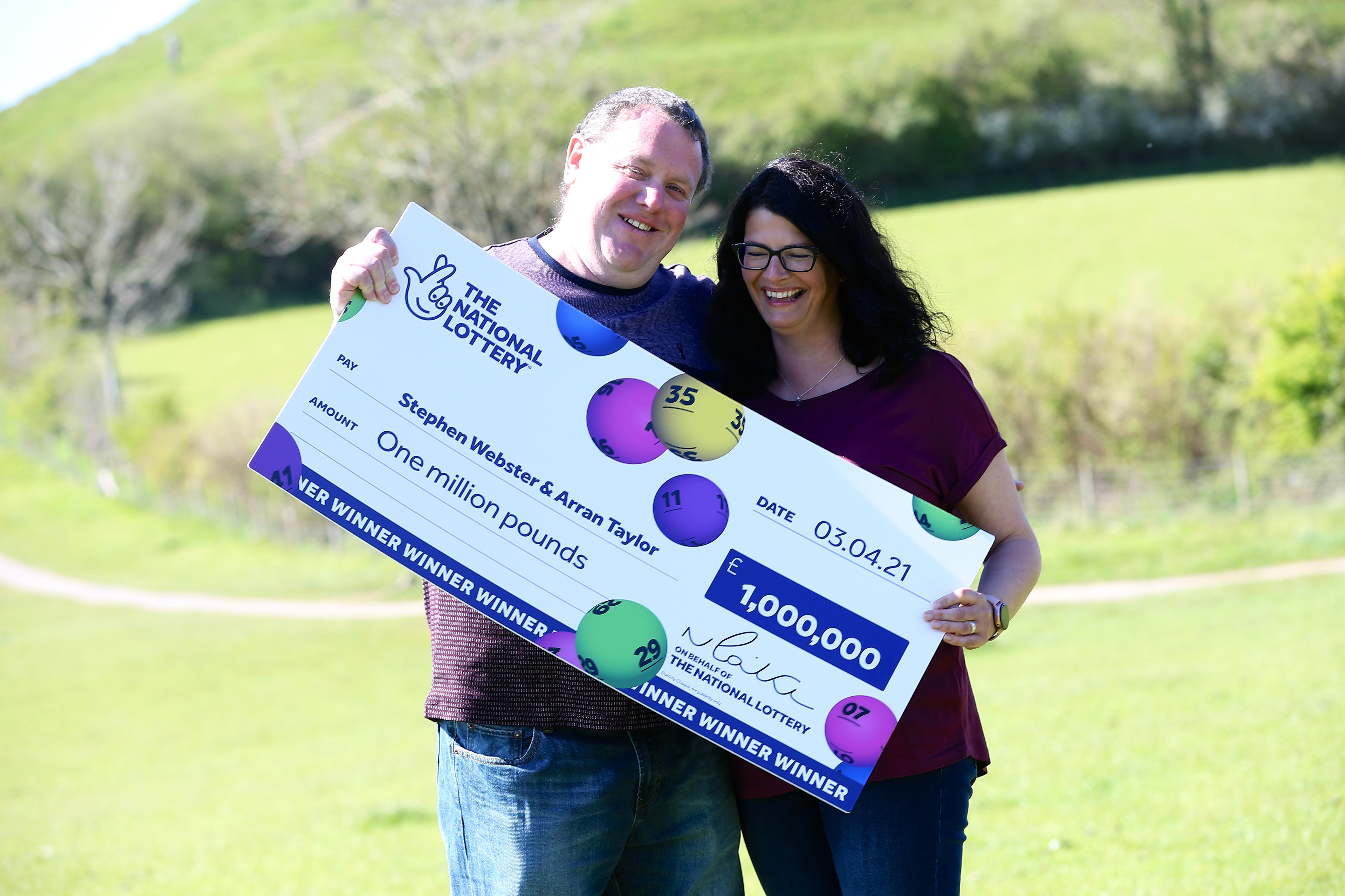 Stephen Webster and partner Arran Taylor plan on taking their children to Disneyland after winning £1 million on the Lotto (The National Lottery/PA).