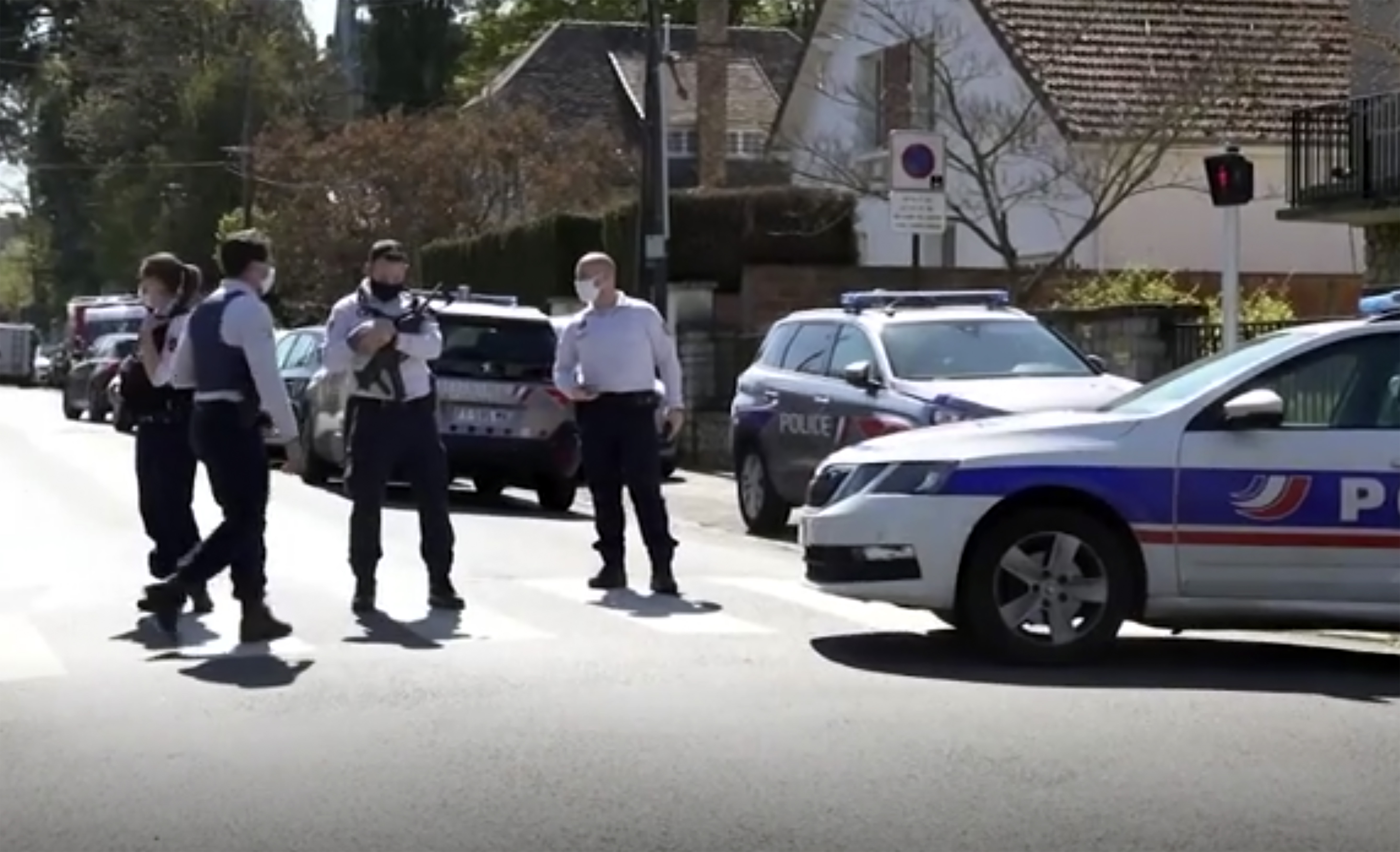Police near the scene of a stabbing at a police station in Rambouillet, south-west of Paris 