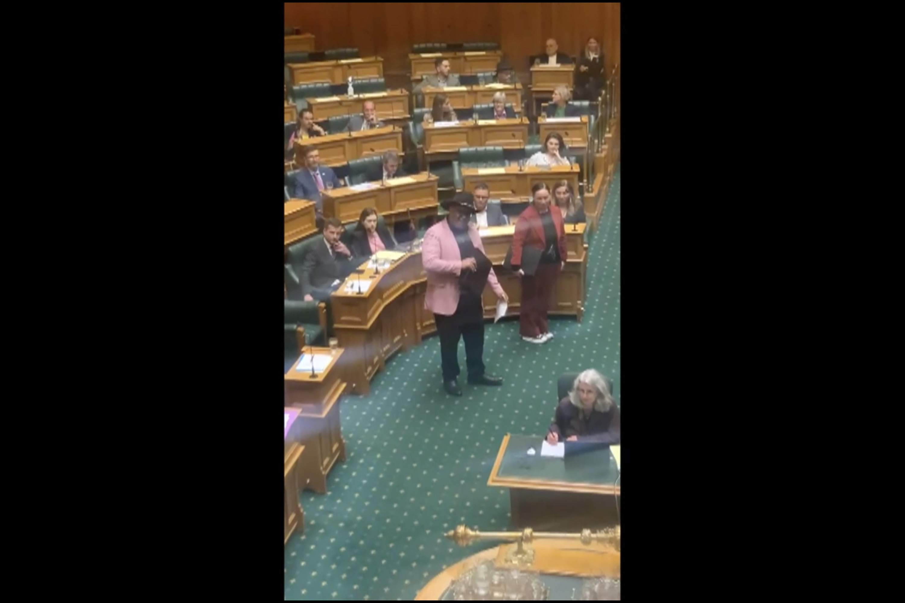 Rawiri Waititi, centre, performs a Maori haka in parliament in Wellington, New Zealand