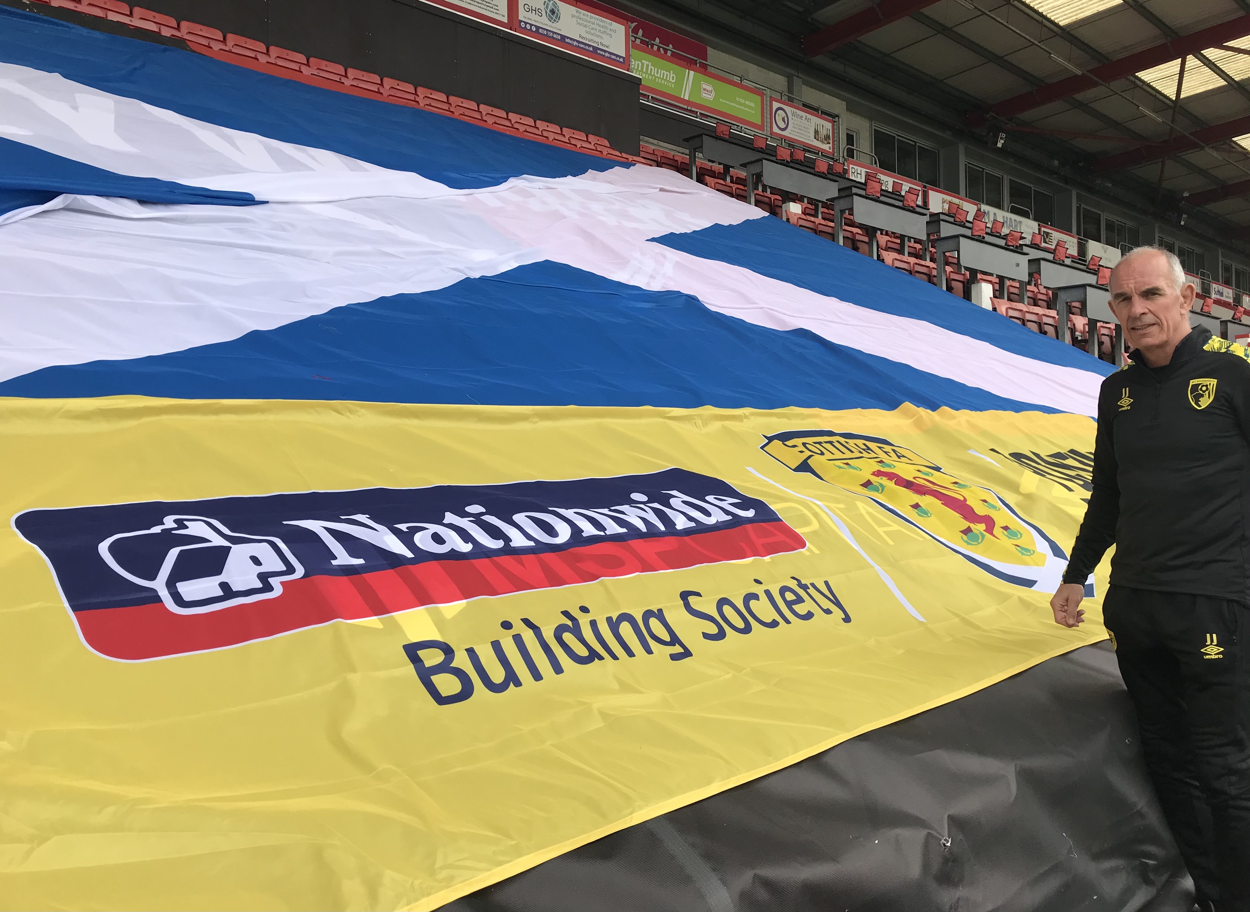 Joe Jordan alongside the Scotland flag 