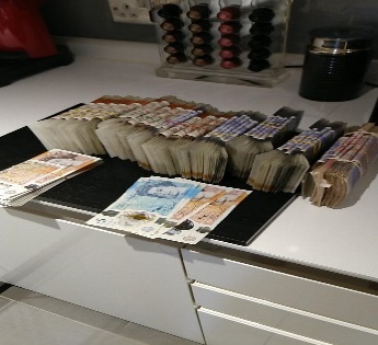 A picture of cash in Catherine Roche's kitchen that was found on her encrypted phone