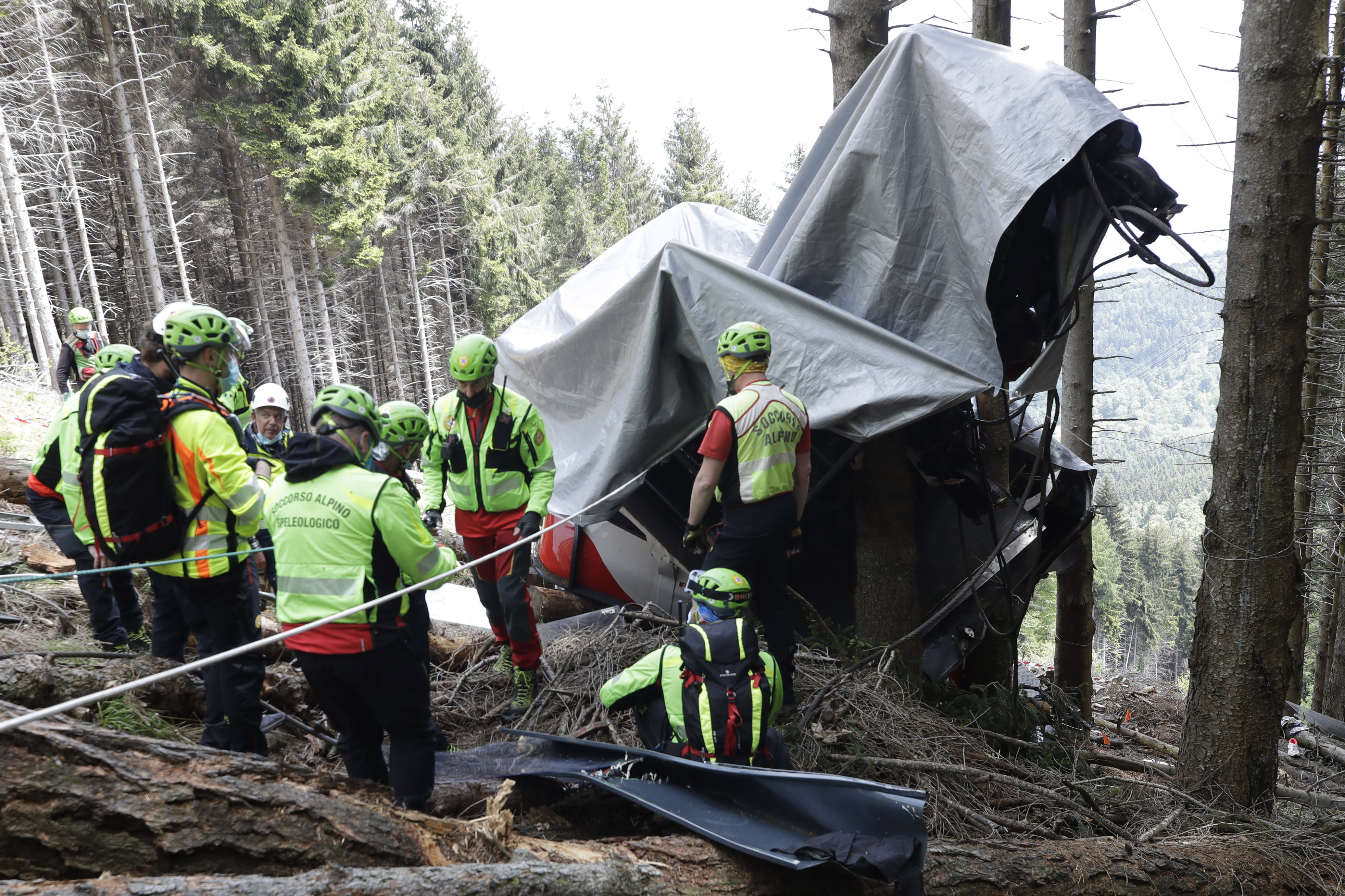 Rescuers search for evidence in the wreckage