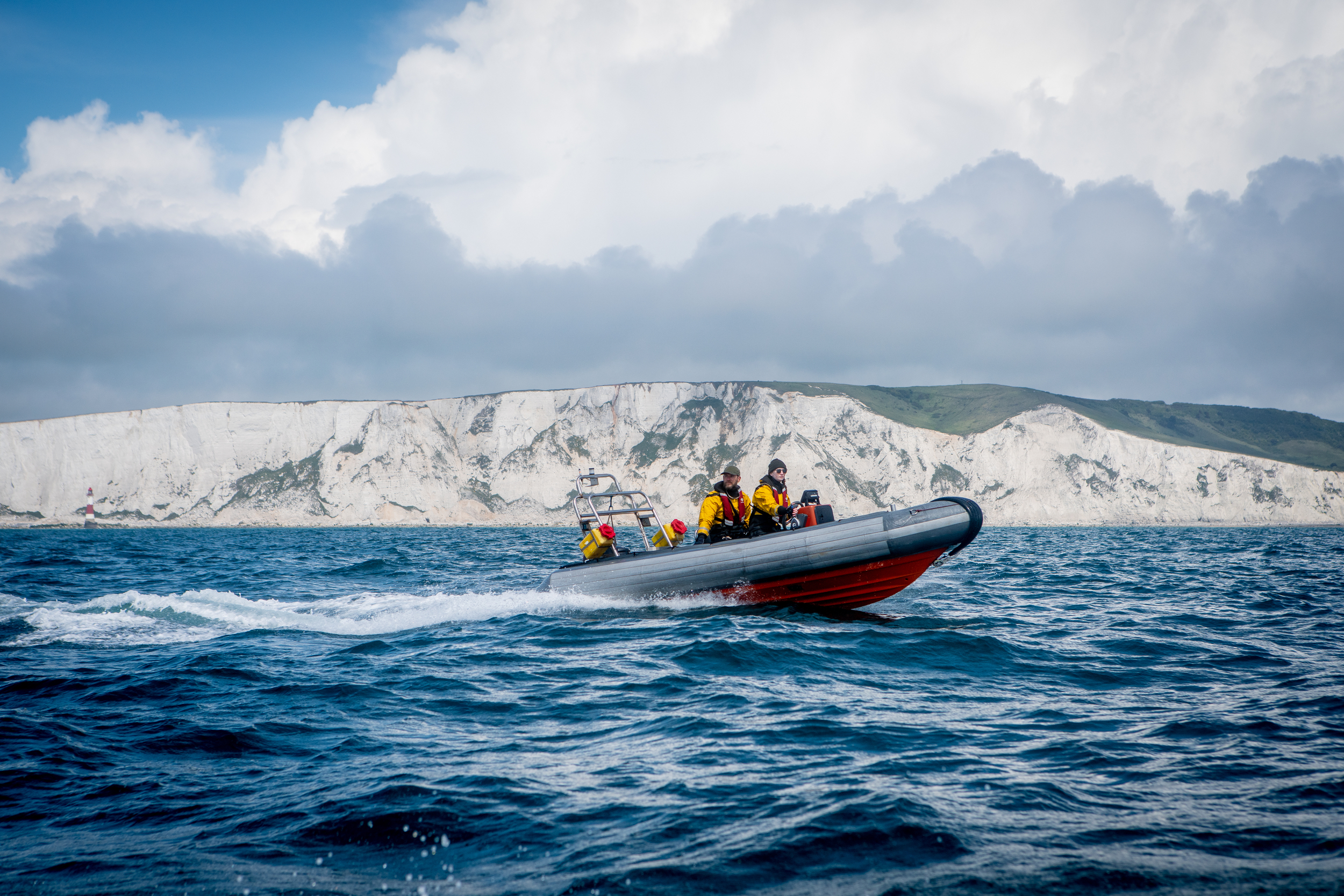 A Greenpeace rib in front of white cliffs in English Channel