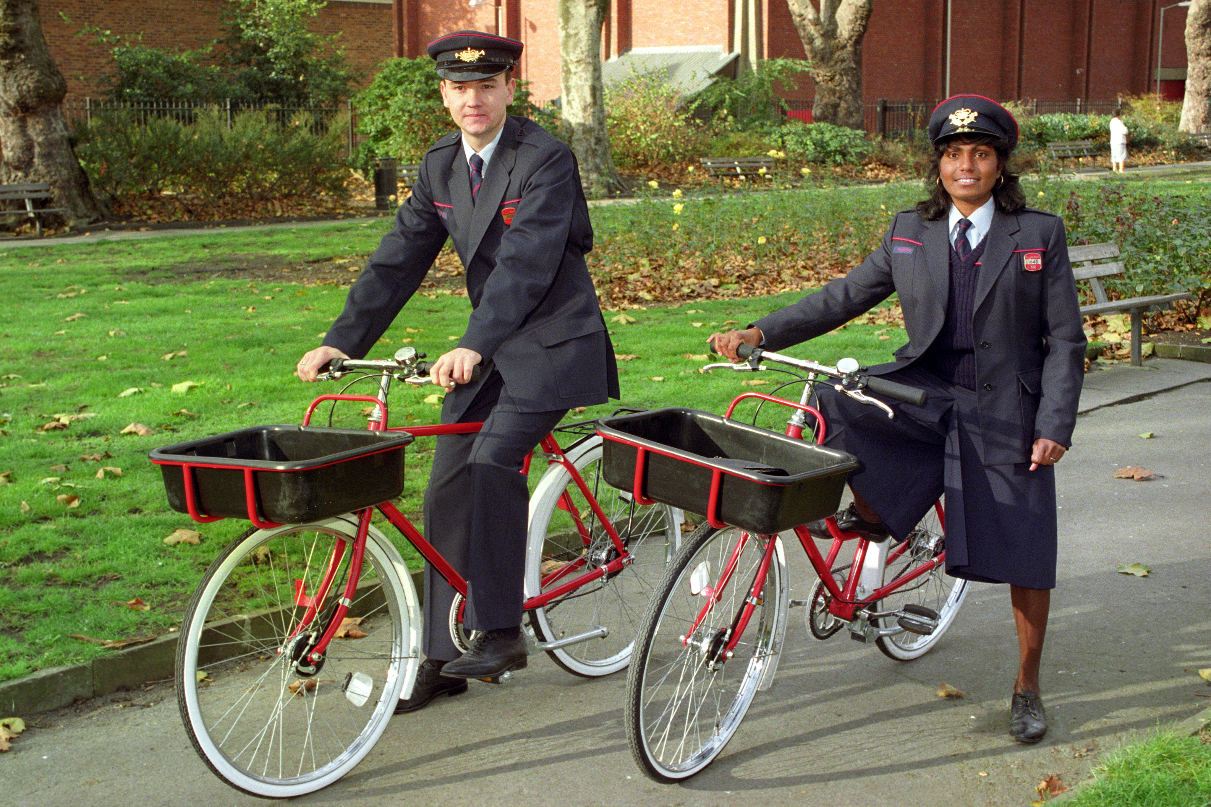Two members of the Royal Mail test their new trial postal bikes in 1990