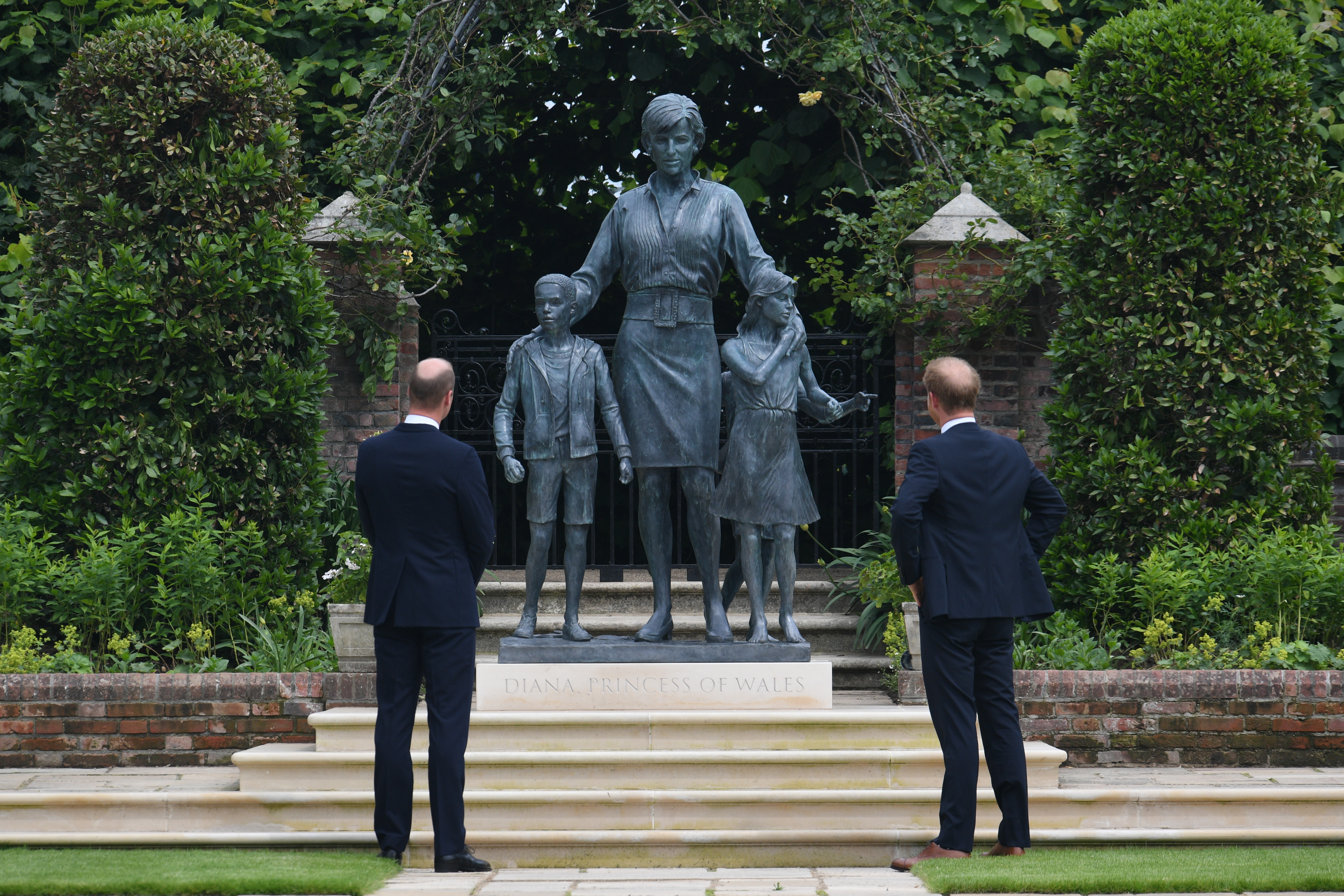 The Duke of Cambridge (left) and Duke of Sussex look at a statue they commissioned of their mother Diana