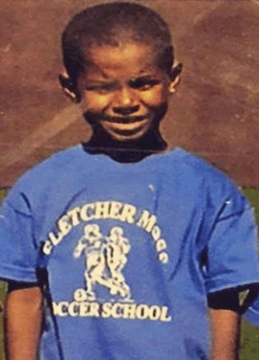 A six-year-old Marcus Rashford wearing a Fletcher Moss soccer school T-shirt