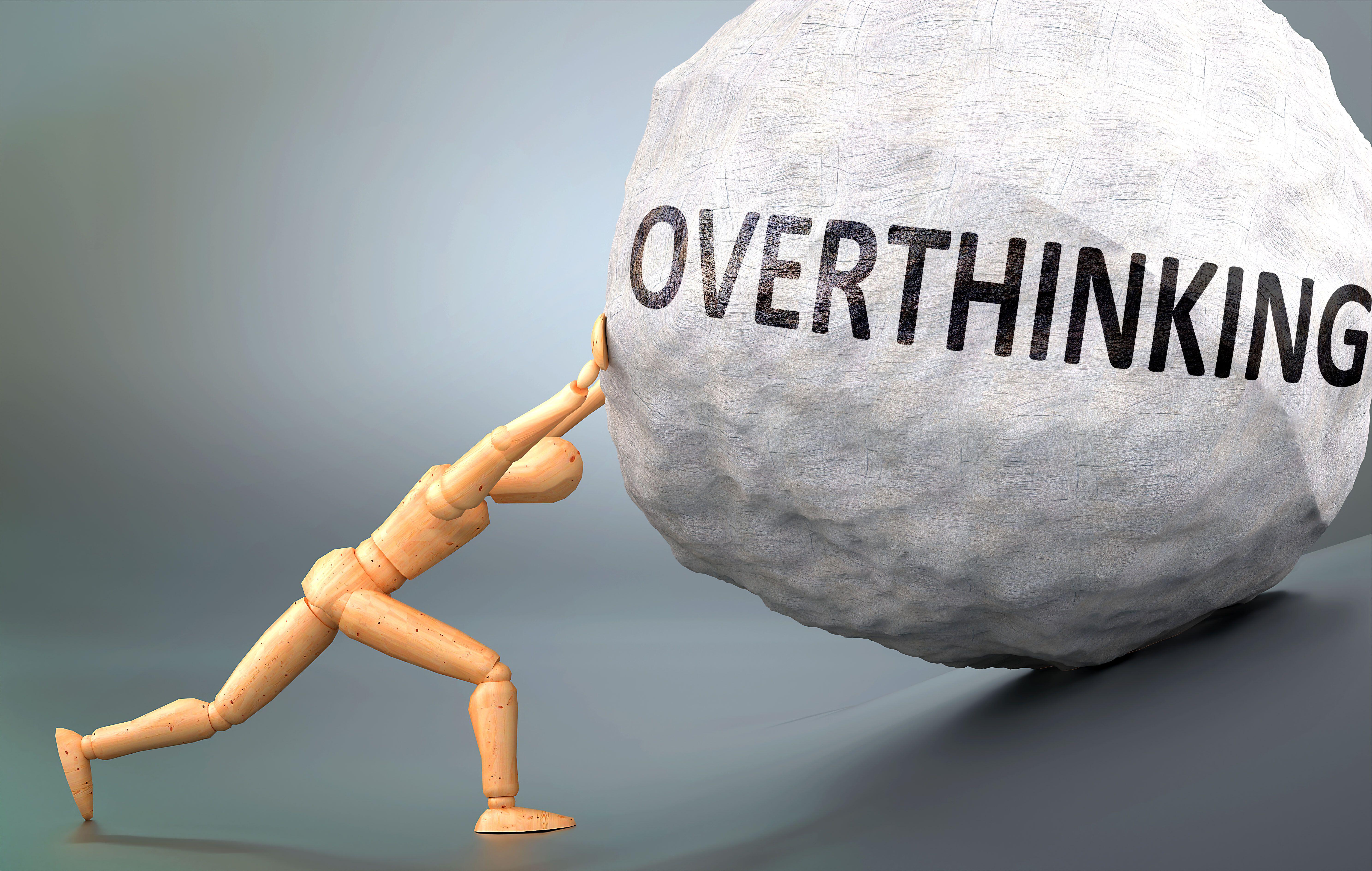 stick figure pushing a boulder labelled 'overthinking'