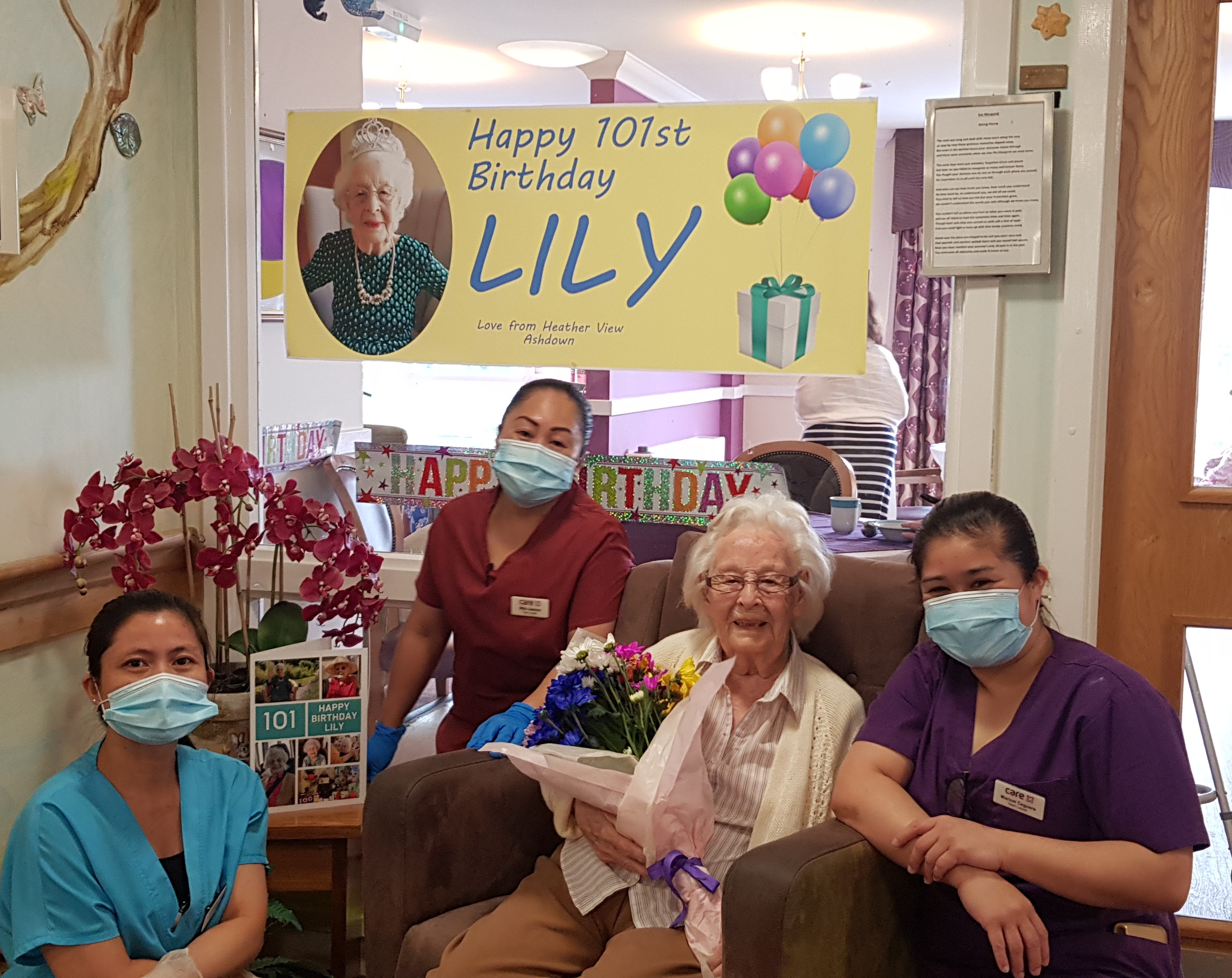 Lily with care home staff