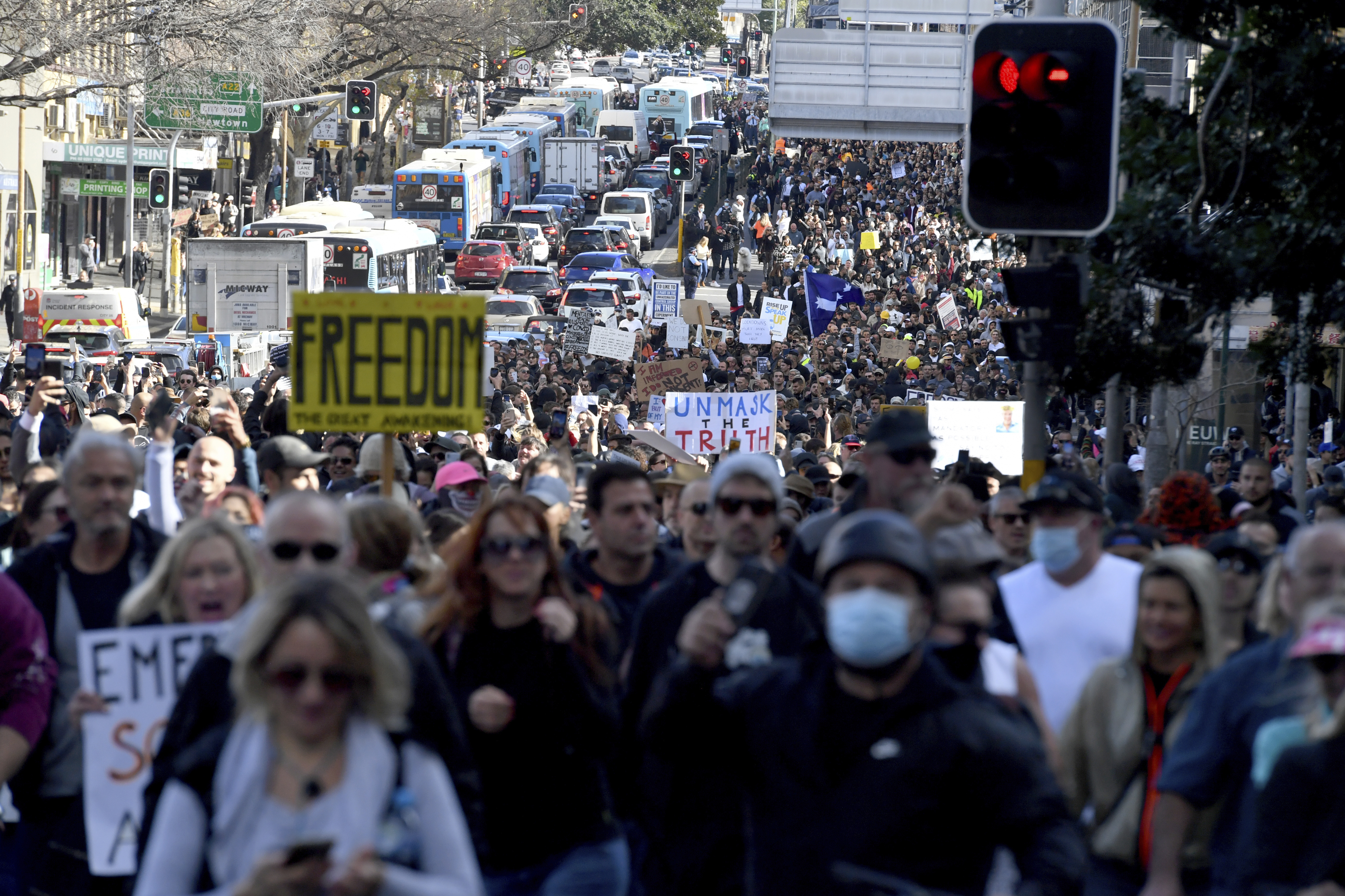 Protesters march through the streets in an anti-lockdown rally in Sydney