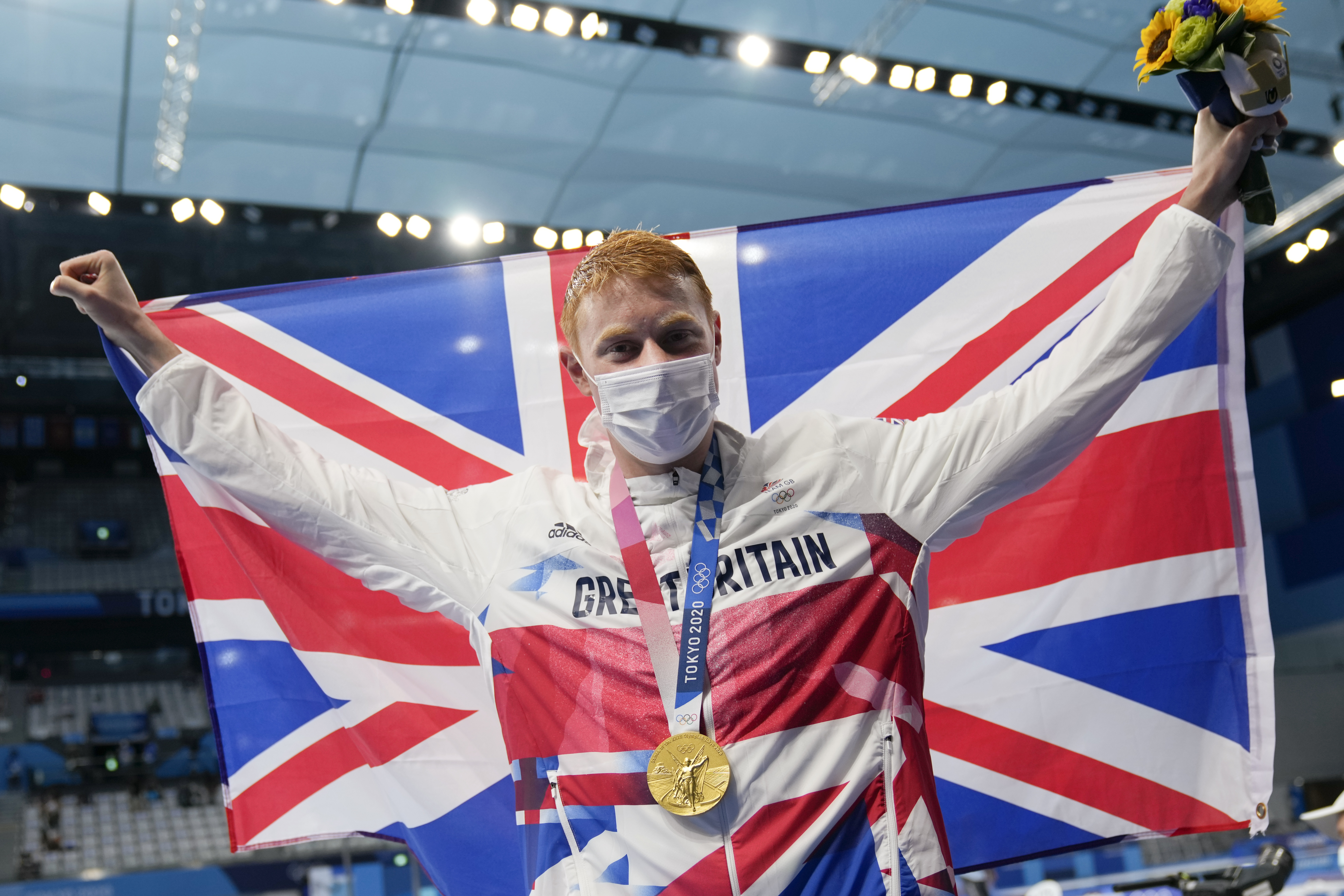 Tom Dean celebrates winning the the men's 200m freestyle