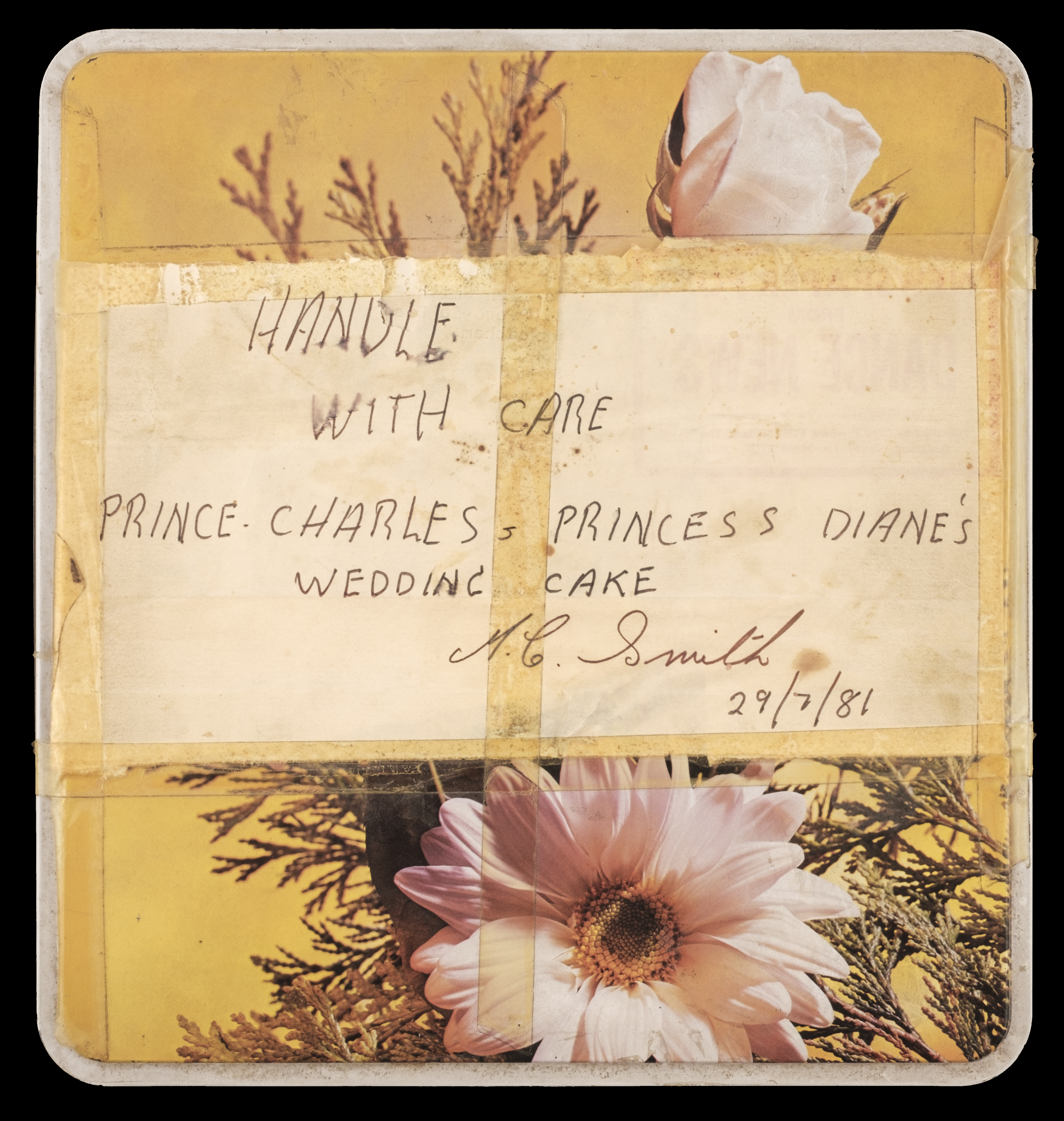 The tin containing the 40-year-old slice of Charles and Diana's wedding cake 