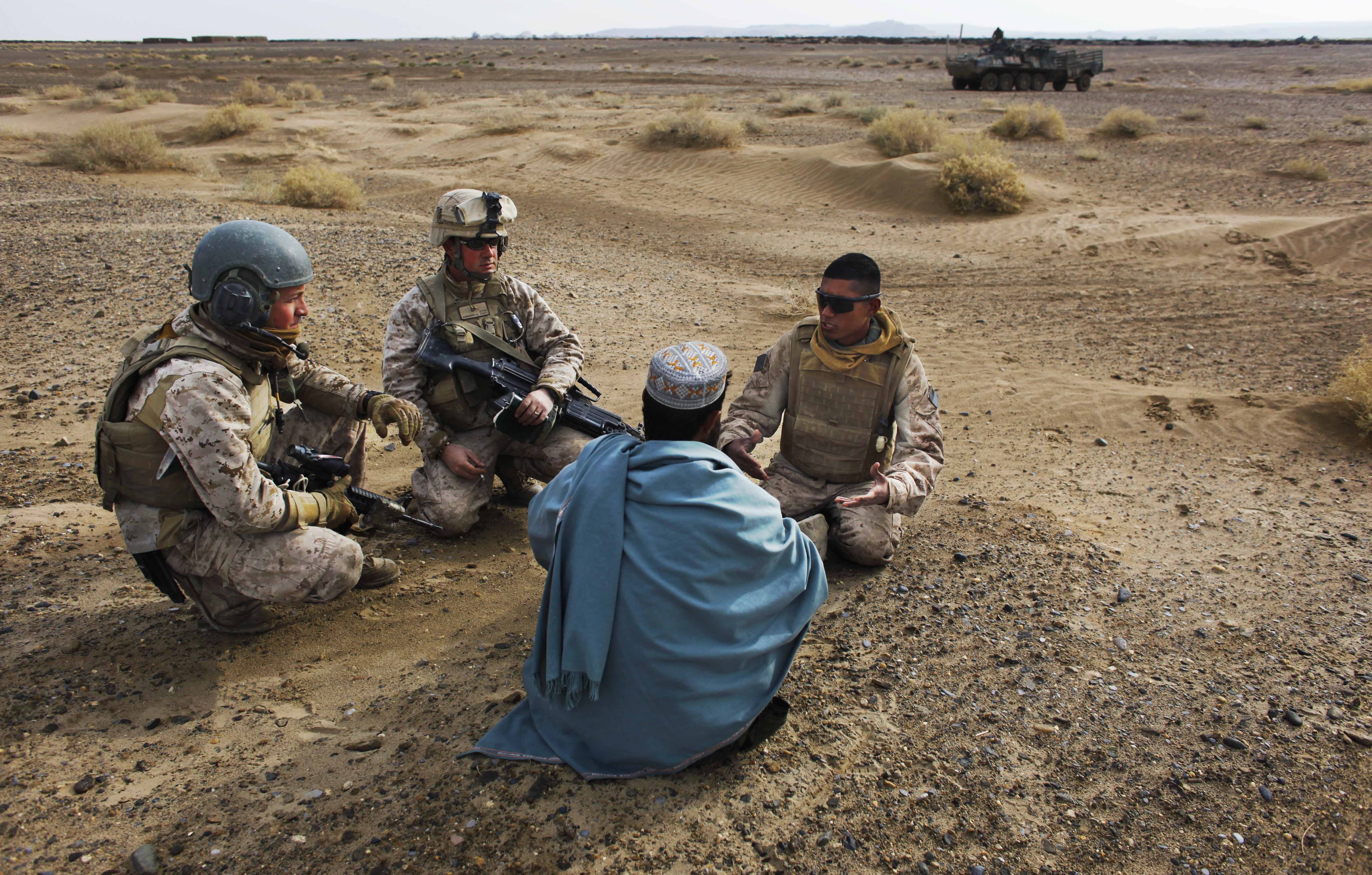 US Marines interview an Afghan man with the help of a translator 