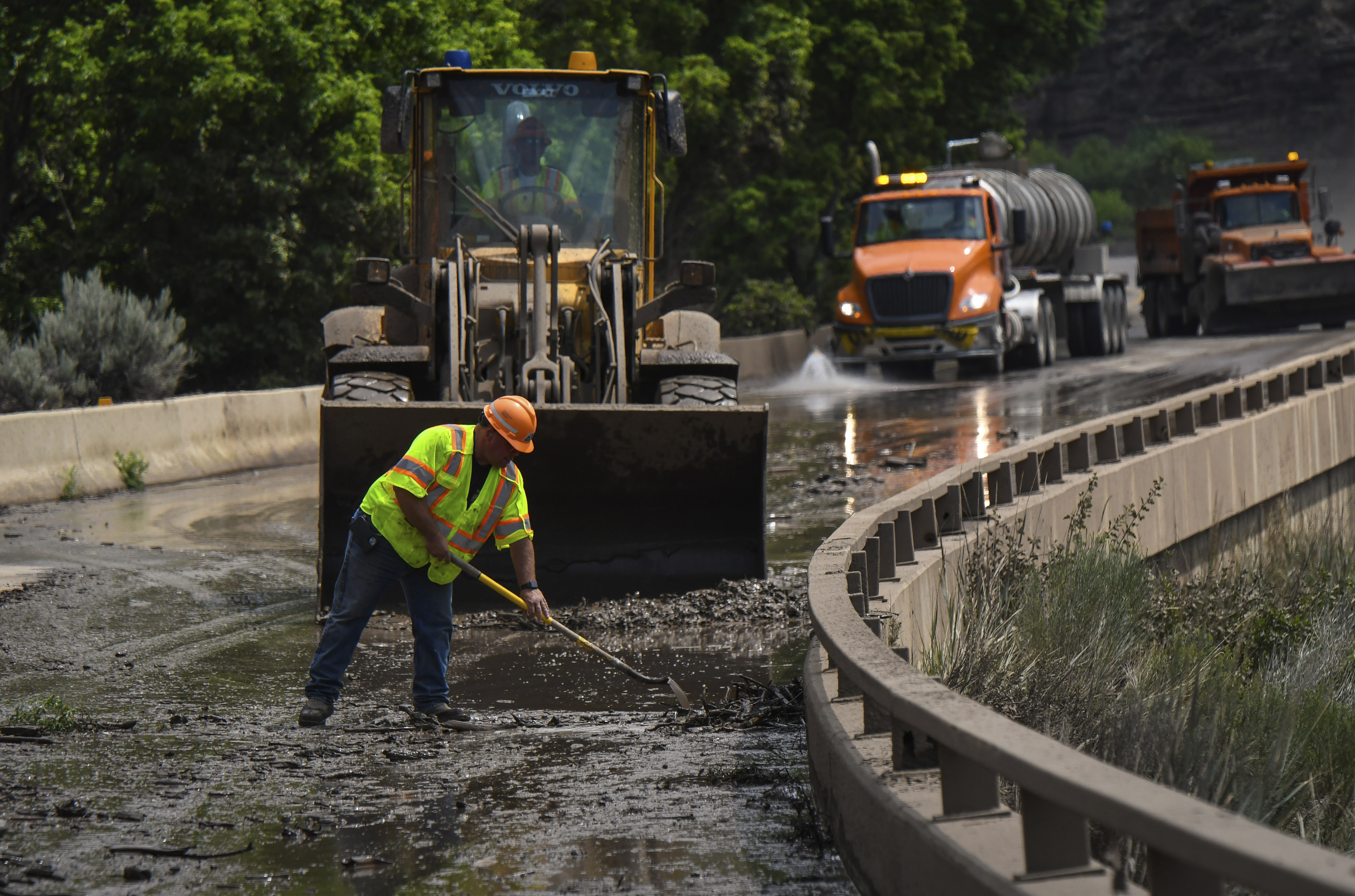 Colorado Department of Transportation crews work to clear mud and debris from the eastbound deck of Interstate 70 through Glenwood Canyon 