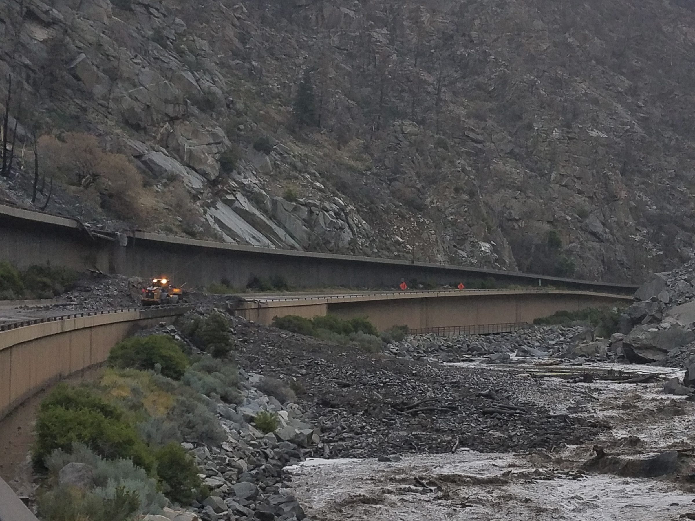 Equipment works to clear mud and debris from a mudslide on Interstate-70 through Glenwood Canyon, Colorado