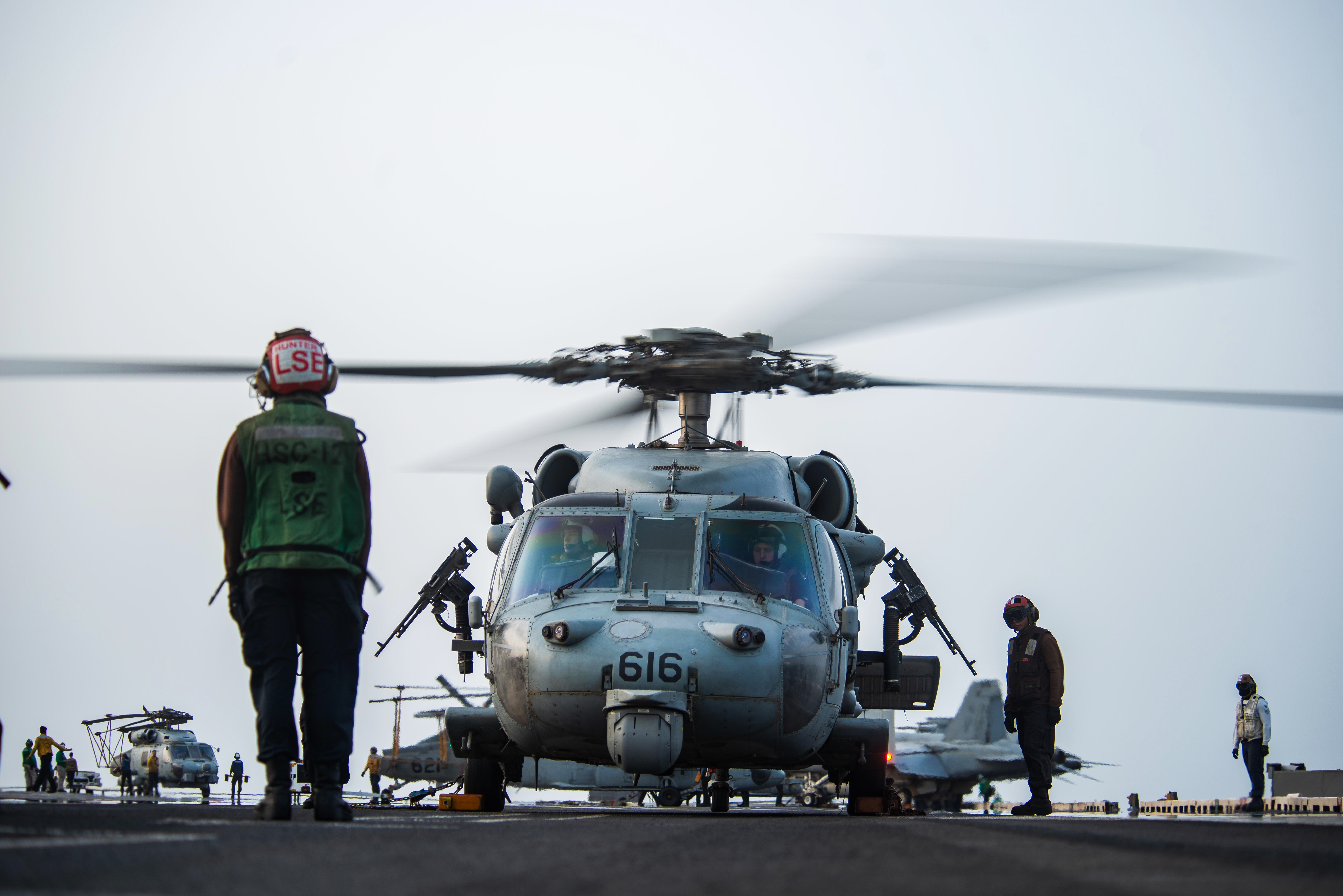 US sailors board a helicopter