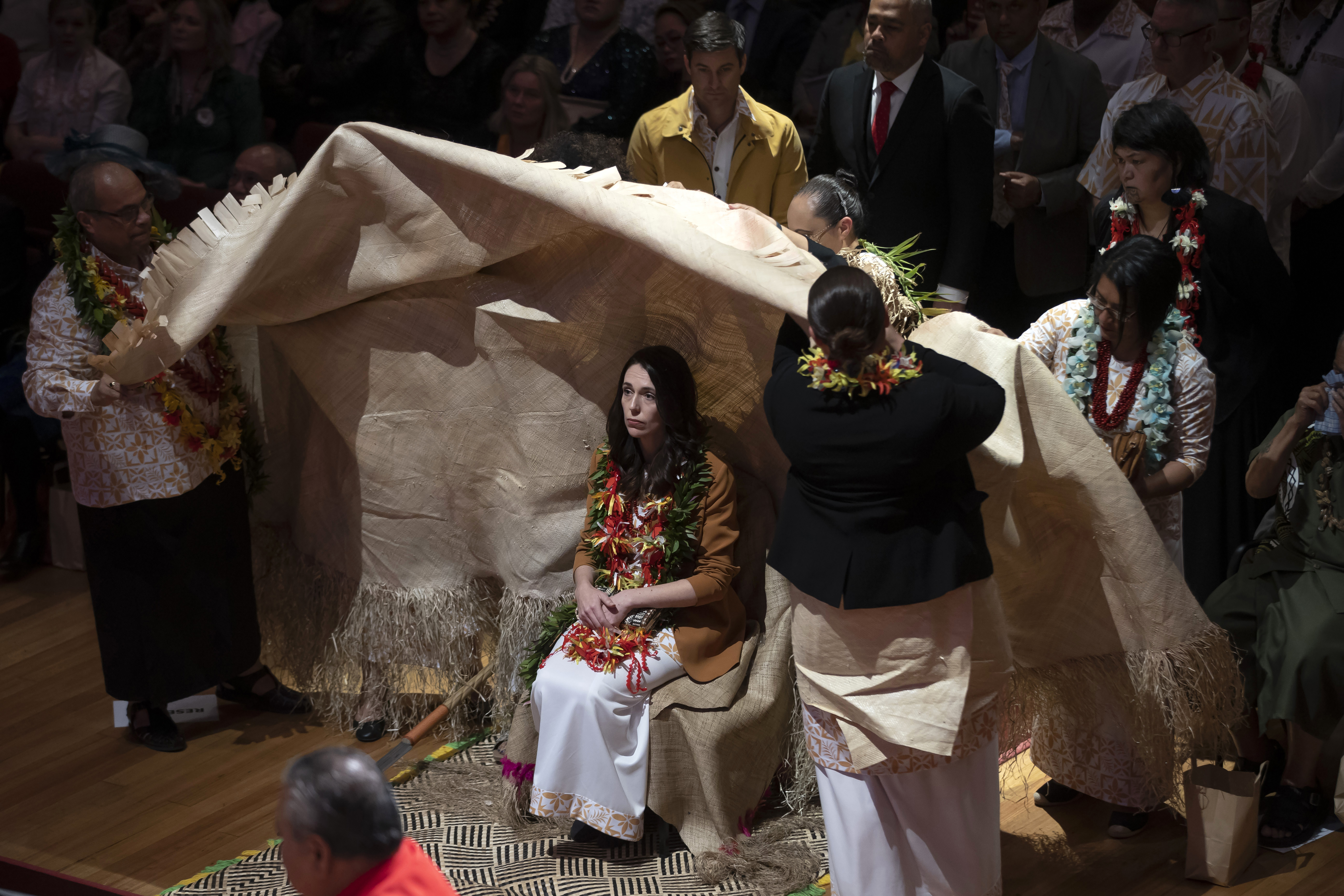 Jacinda Ardern is covered during the ceremony in Auckland