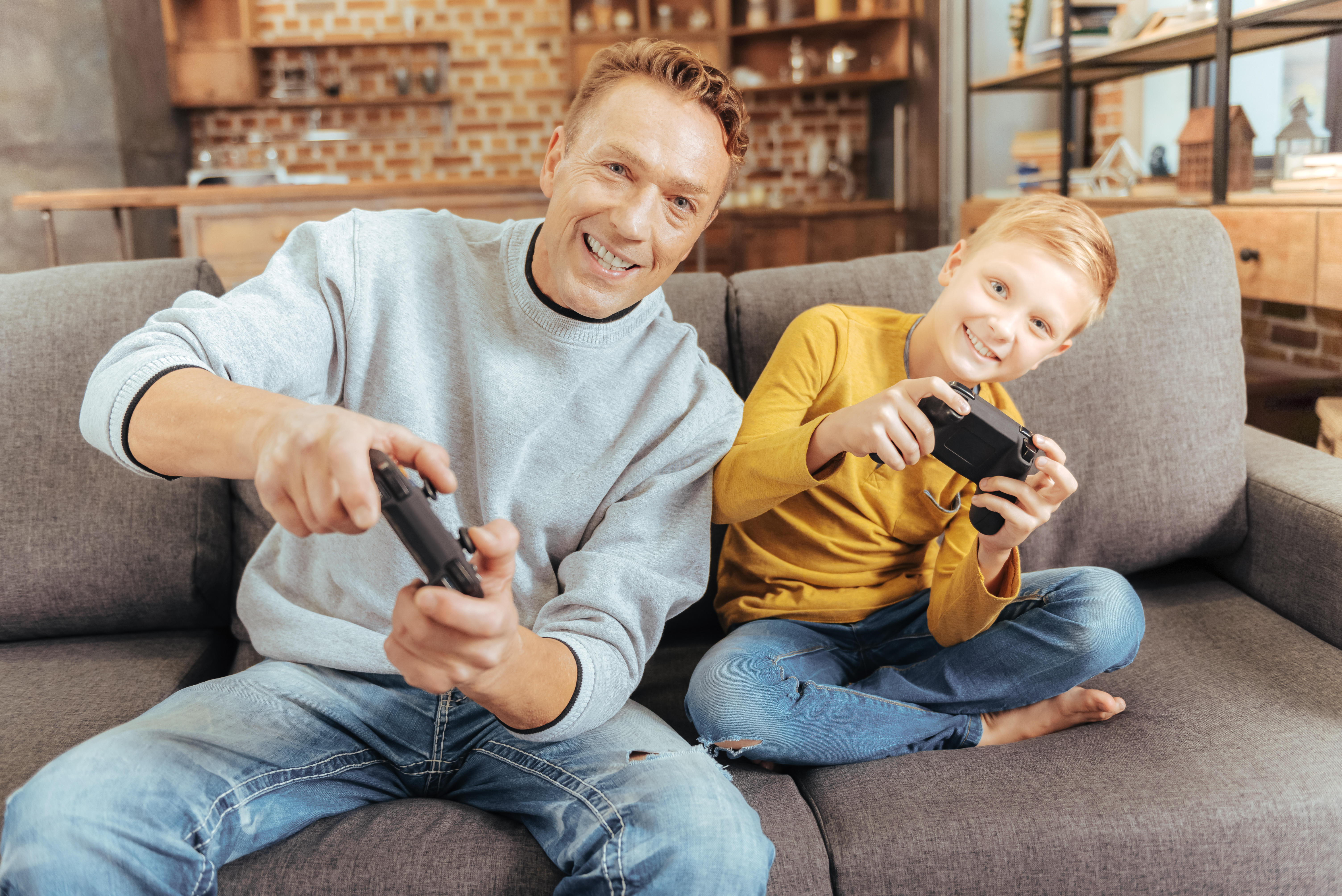 father and son playing video games