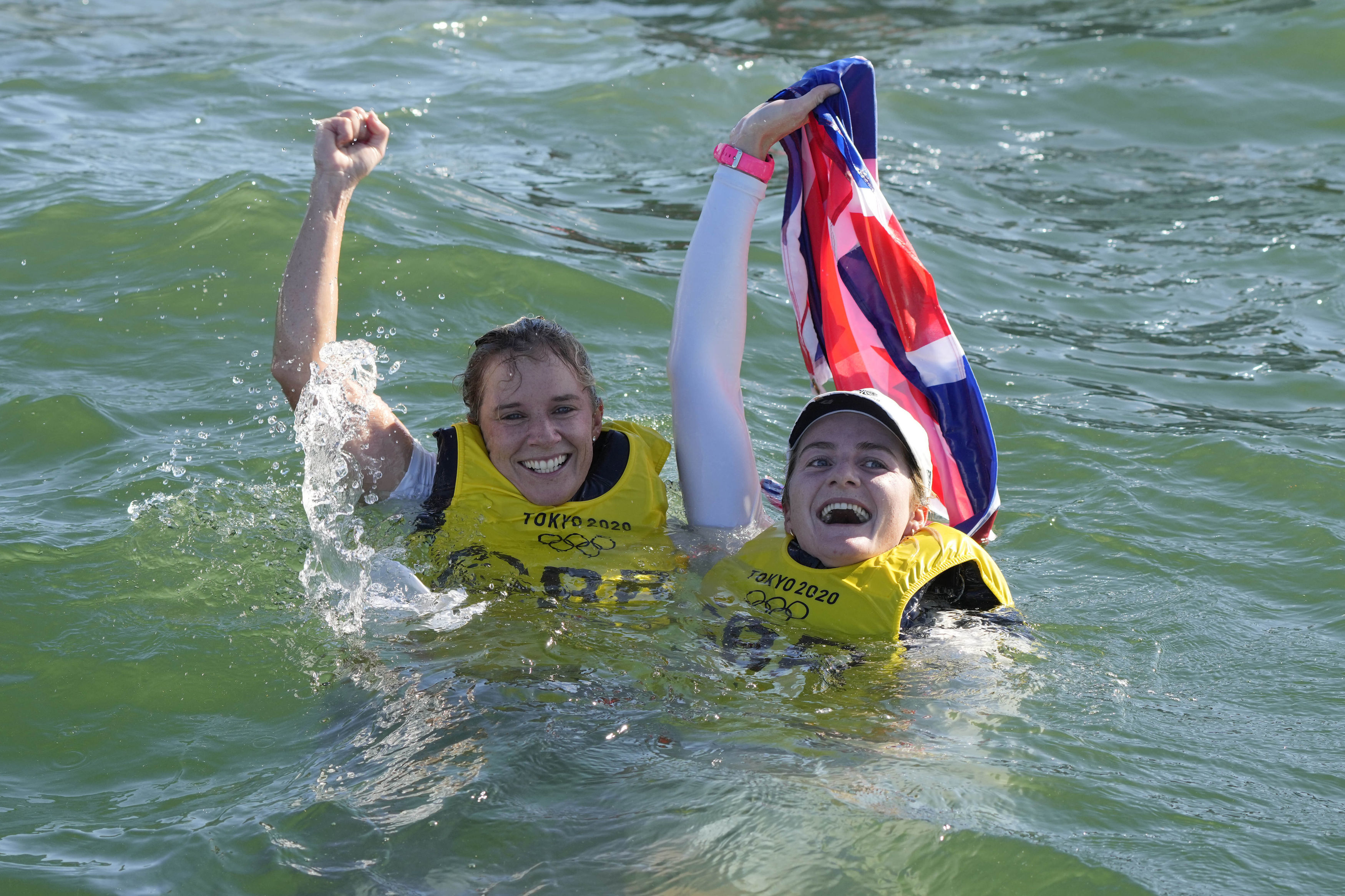 Hannah Mills and Eilidh McIntyre celebrate their golds in the sea