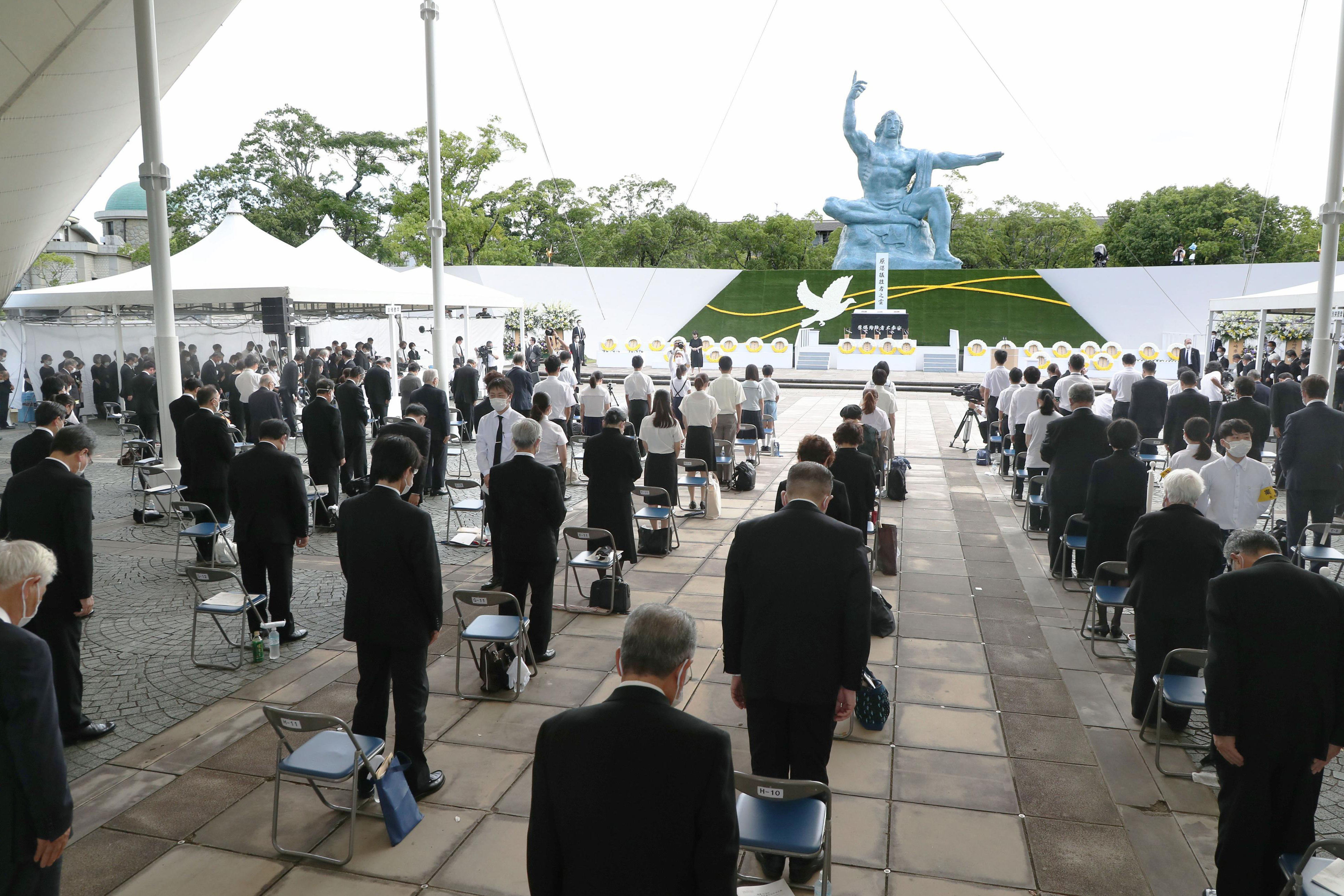 Attendees offer a silent prayer for the victims of the US atomic bombing at the time when the bomb was dropped