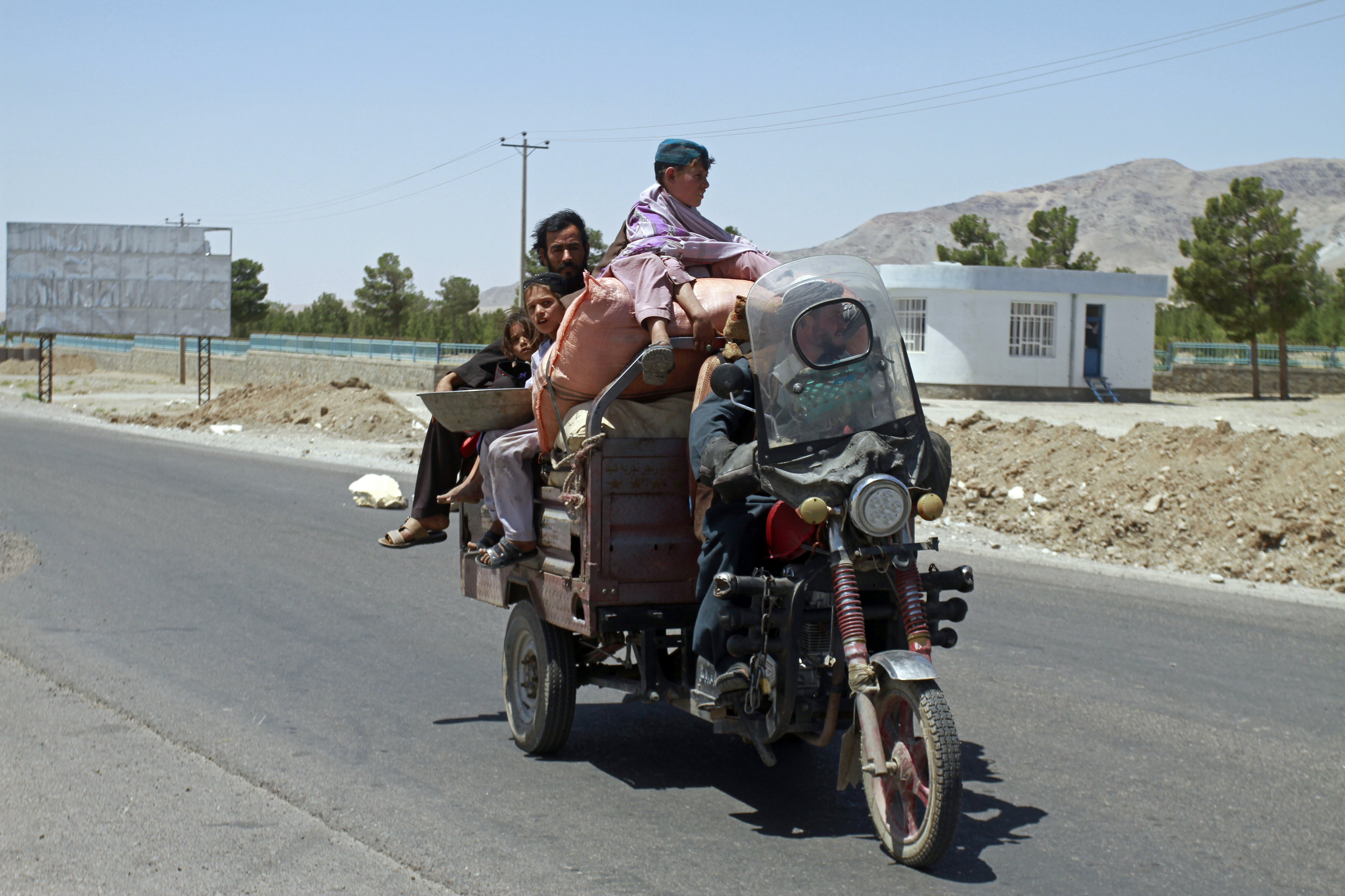 An Afghan family flees fighting as Afghan security personnel took back control of parts of the city of Herat following fighting between Taliban and Afghan security forces, on the outskirts of Herat, 640 kilometers (397 miles) west of Kabul, Afghanistan