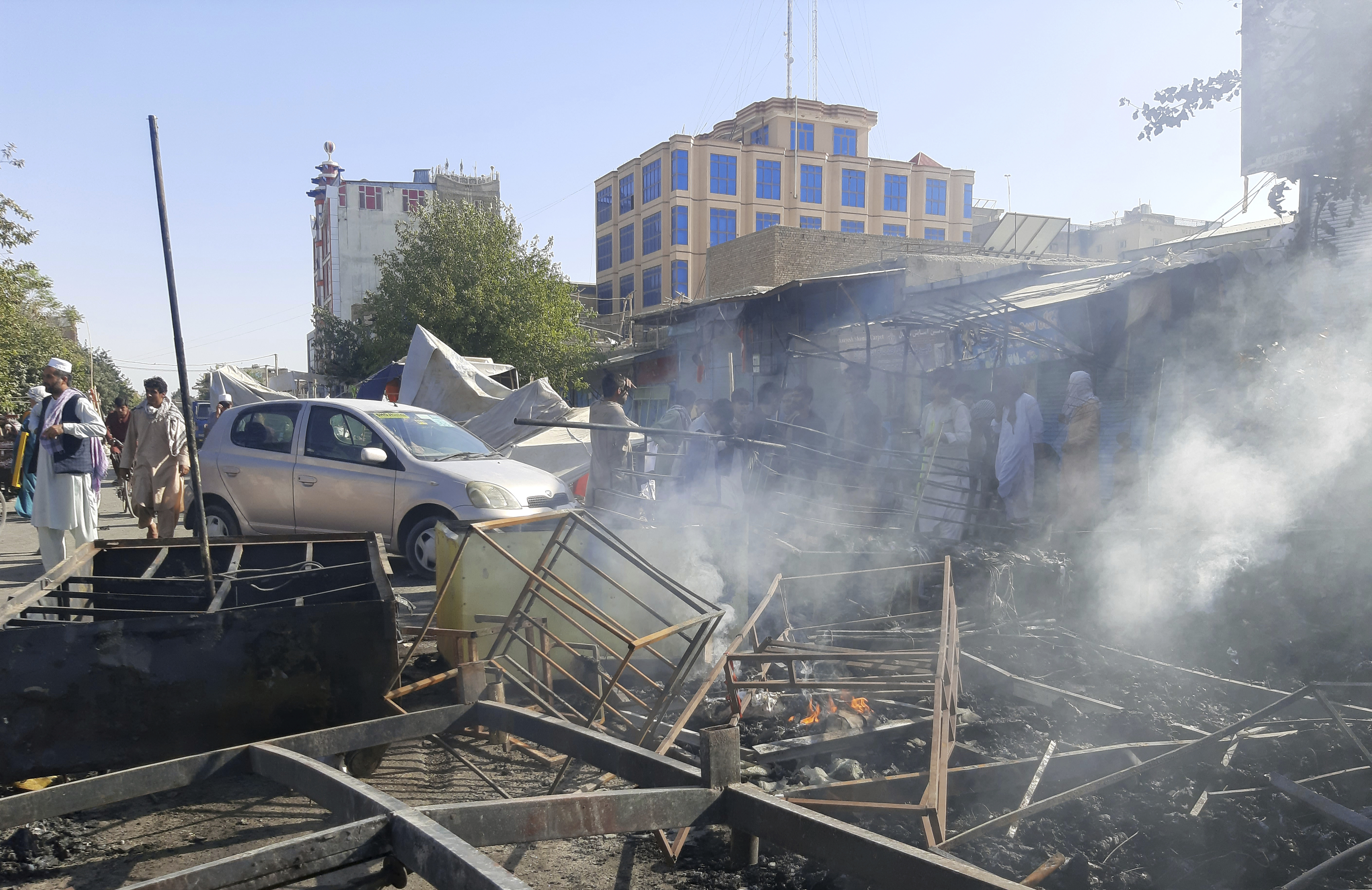 Smoke rises from damaged shops after fighting between Taliban and Afghan security forces in Kunduz city, northern Afghanistan 