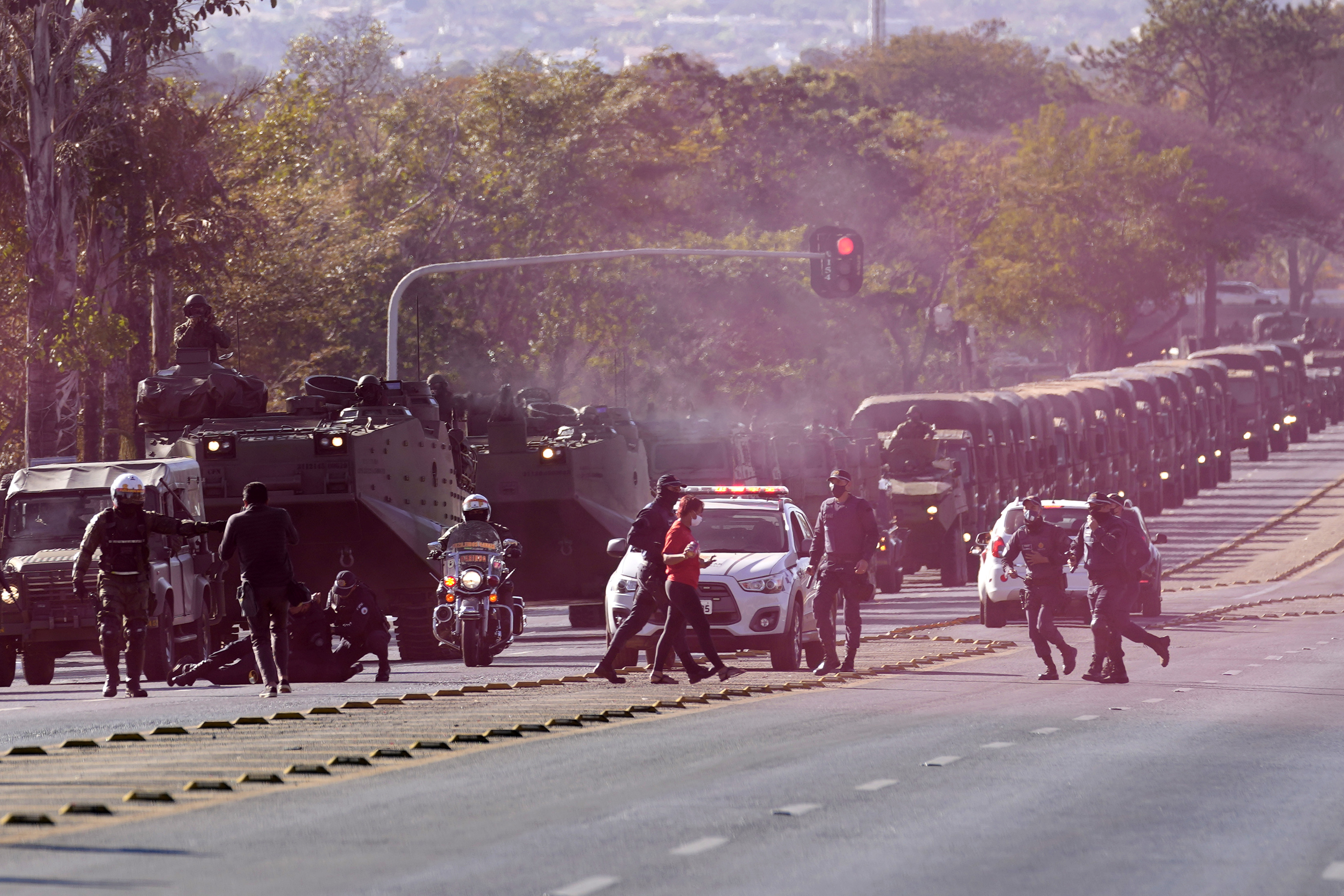 Military police detain two protesters blocking the convoy