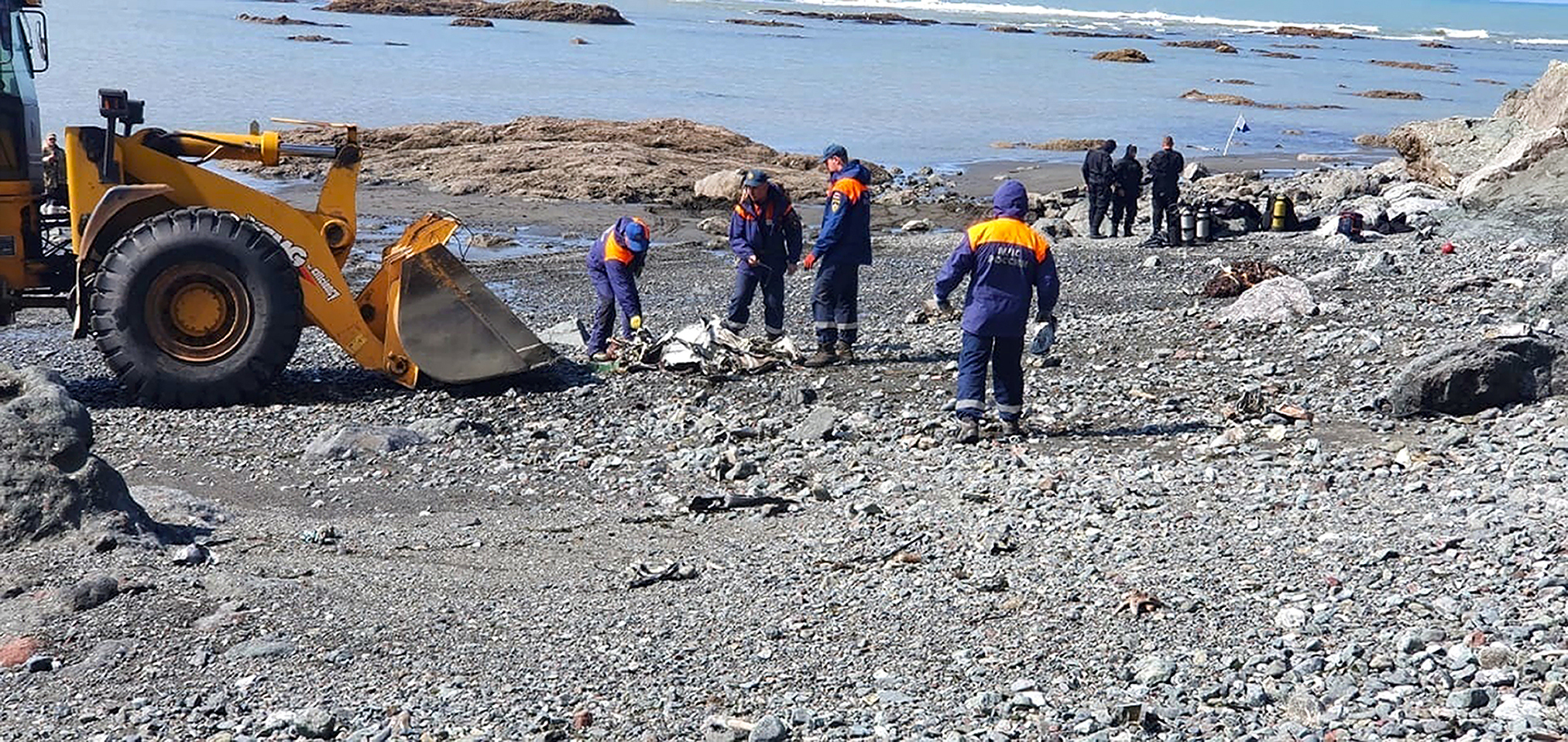 Emergency personnel work near the site where a helicopter carrying tourists crashed at Kurile Lake in the Kronotsky nature reserve 