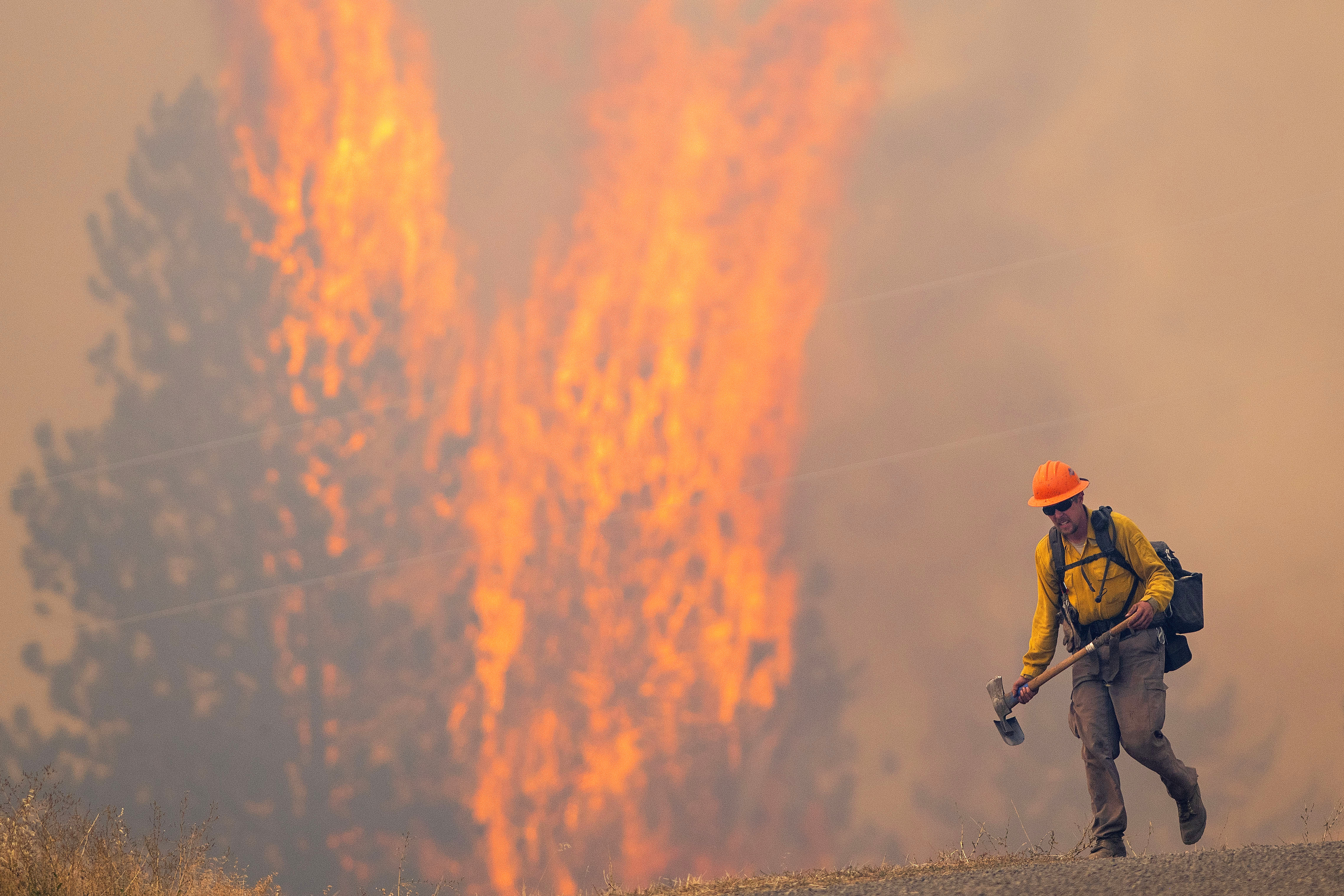 A wildland firefighter grimaces