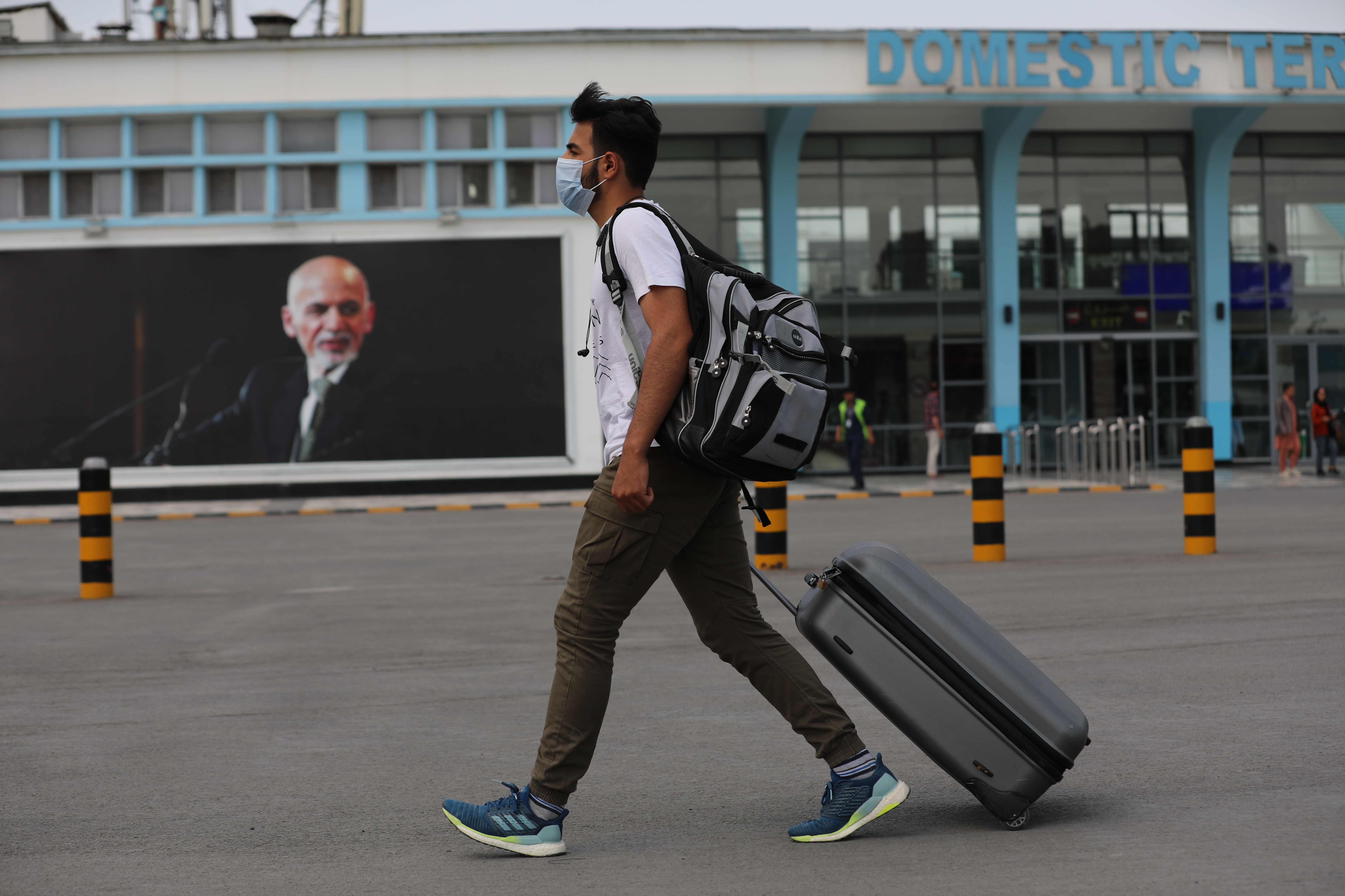 A passenger walks to the departures terminal of Hamid Karzai International Airport in Kabul, Afghanistan