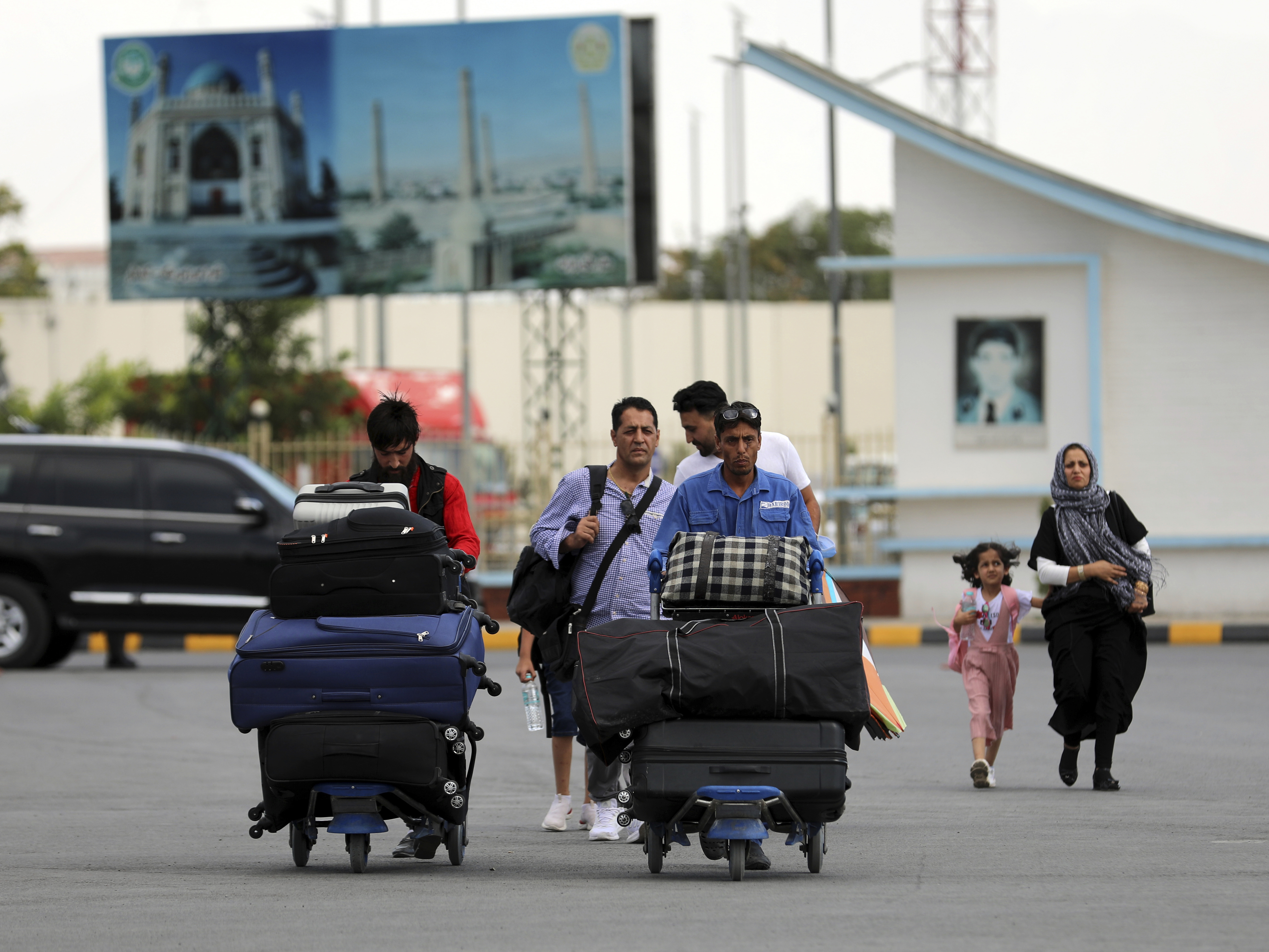 Passengers walk to the departures terminal of Hamid Karzai International Airport in Kabul, Afghanistan