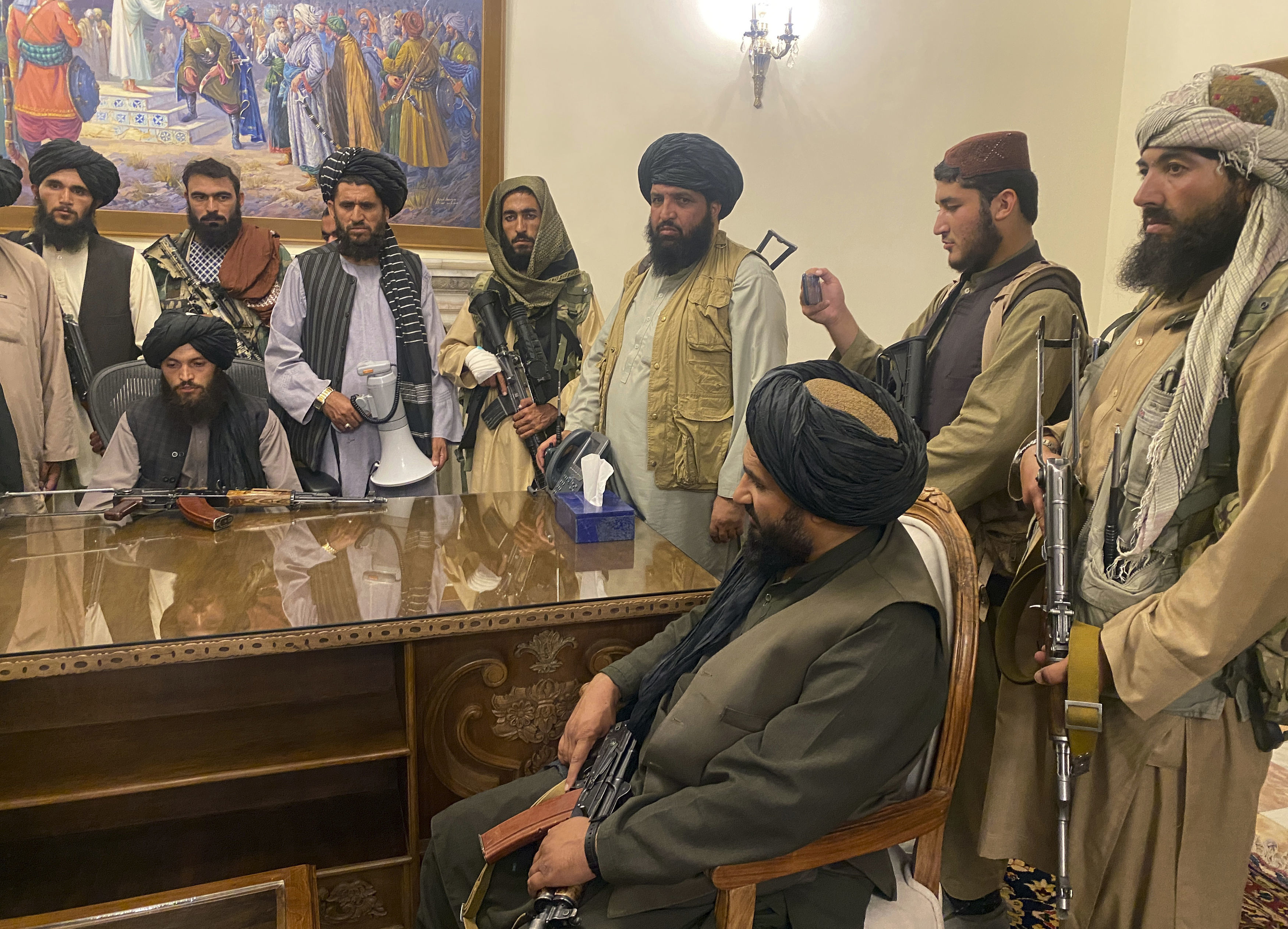 Taliban fighters take control of Afghan presidential palace after the Afghan President Ashraf Ghani fled the country, in Kabul, Afghanistan (Zabi Karimi/AP)