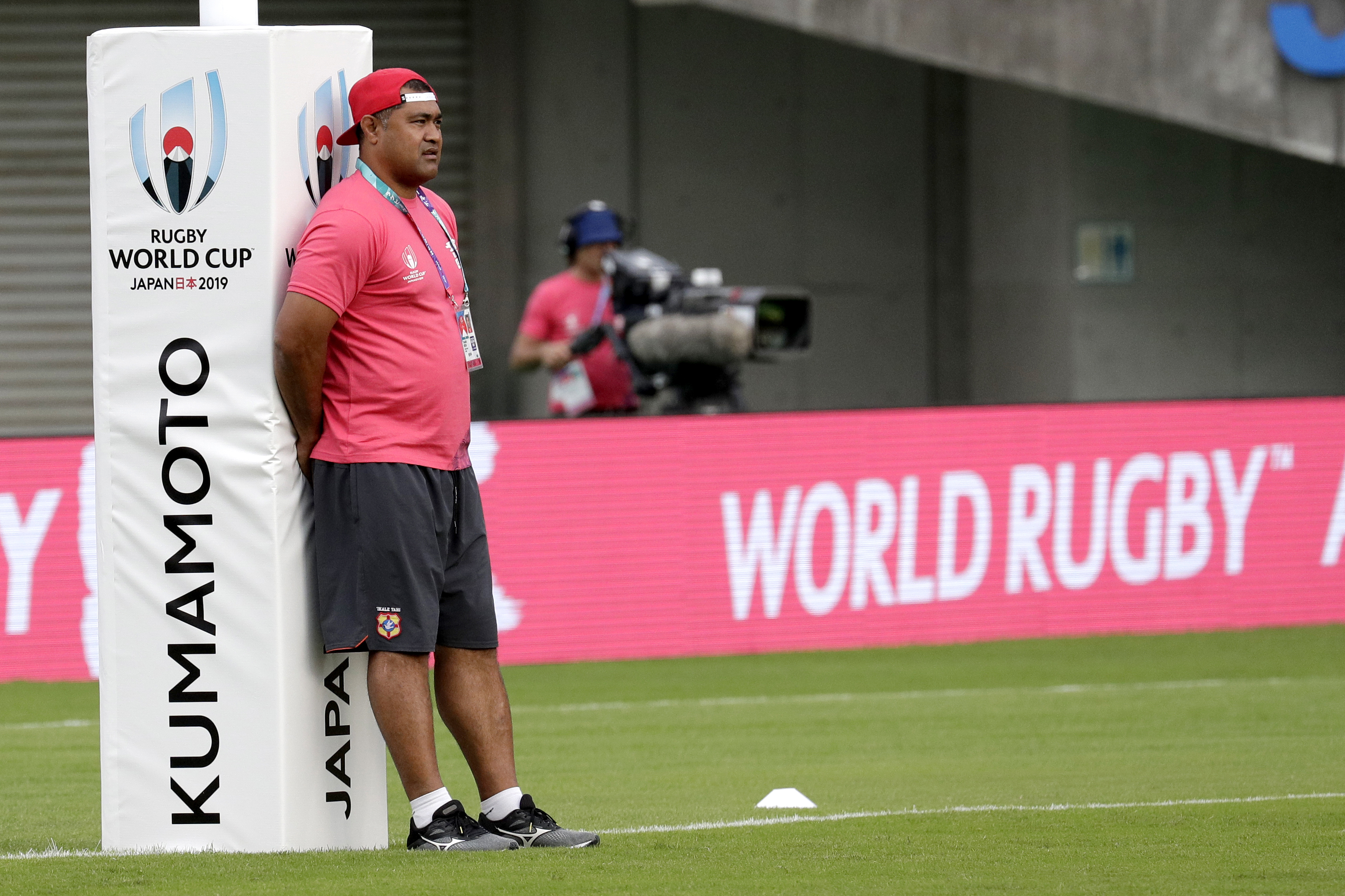 Tonga coach Toutai Kefu watches his players warm up