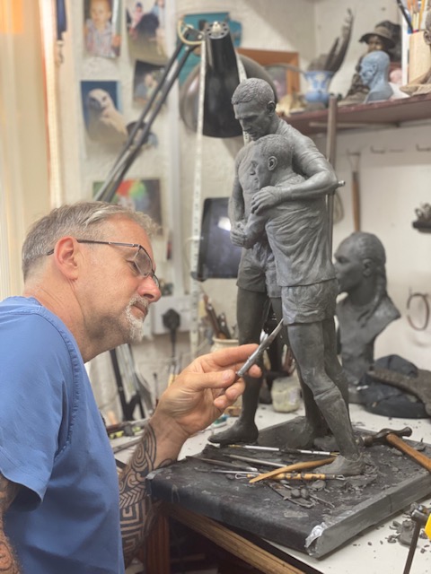 Sculptor Steve Winterburn works on a preliminary model of the statue 