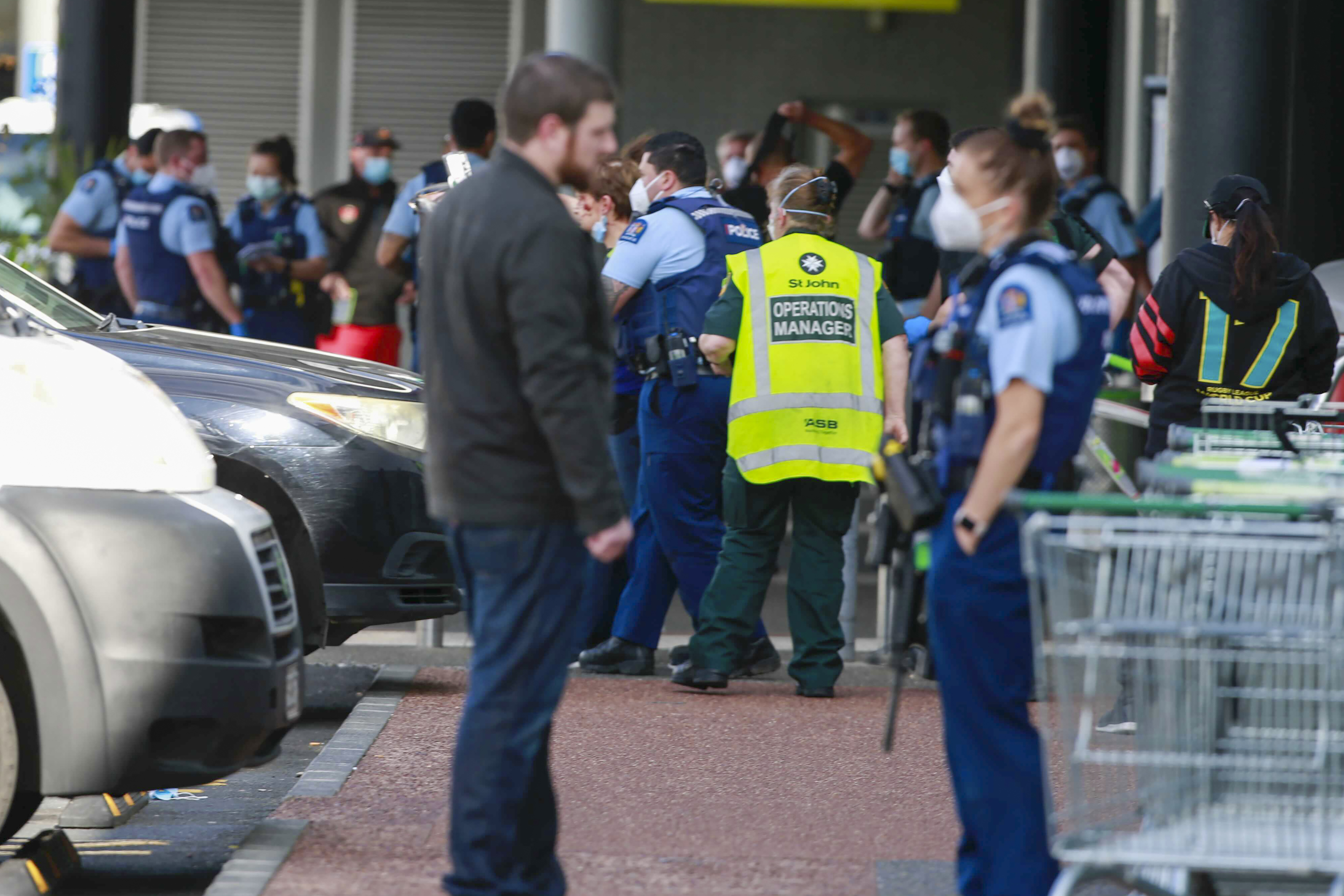 Police and ambulance staff attend the scene outside an Auckland supermarket