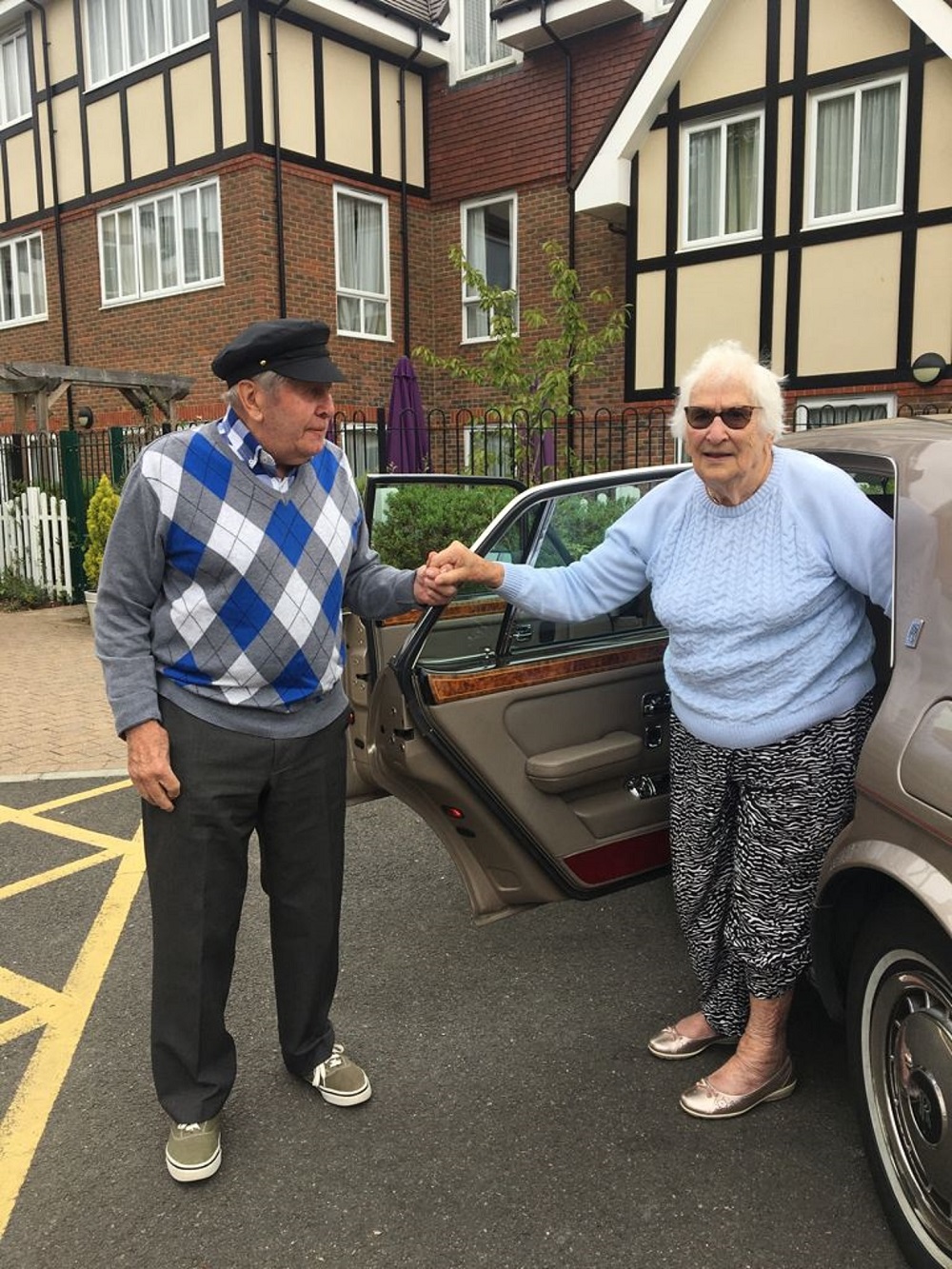 Alec Goy helping fellow resident Eve out of the Rolls Royce