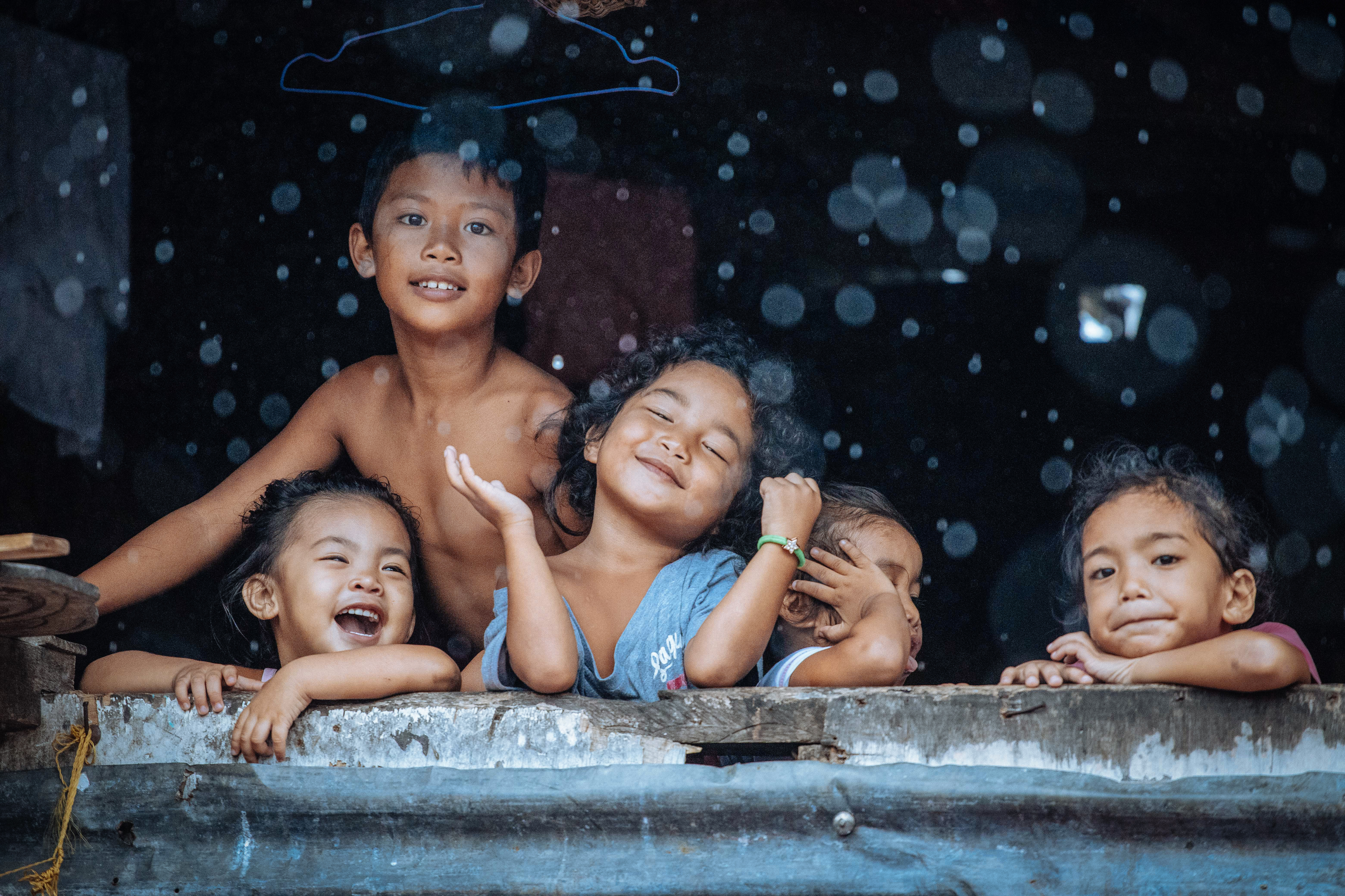 A group of young children in the Philippines smiling and laughing, captured by Hartmut Schwartzbach from Germany