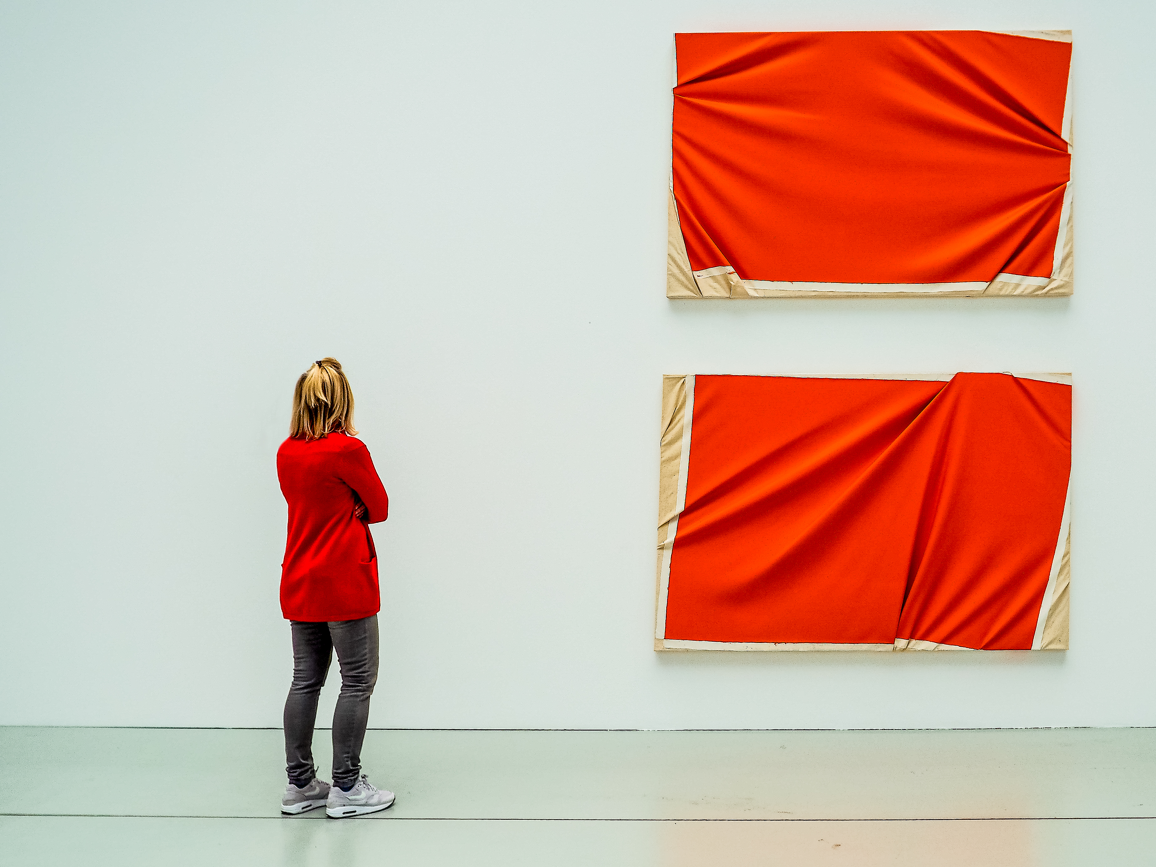 A woman views a brightly coloured work of art that matches her outfit in this image captured by Hans Lahodny from Austria