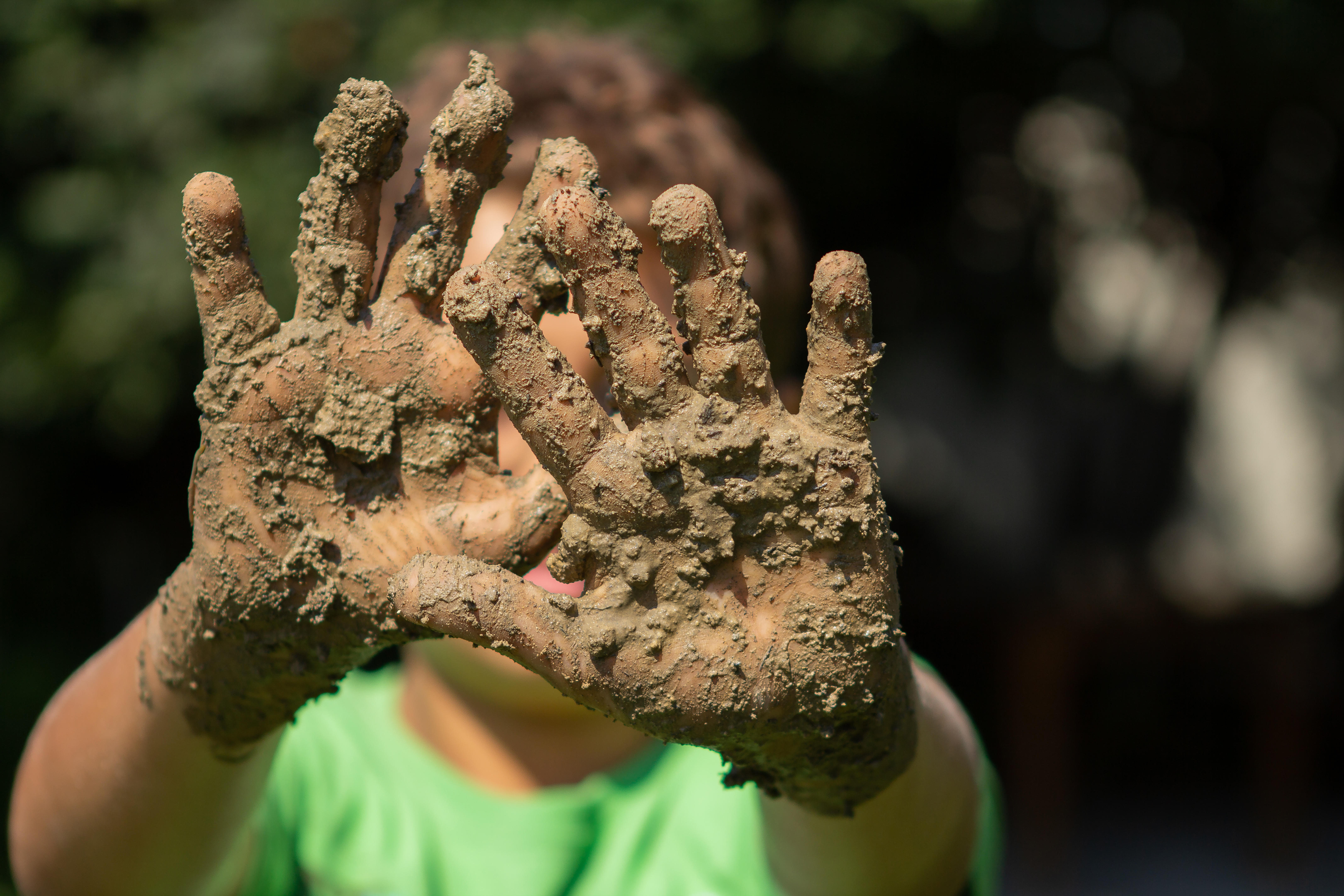 A child with muddy hands (Alamy/PA)