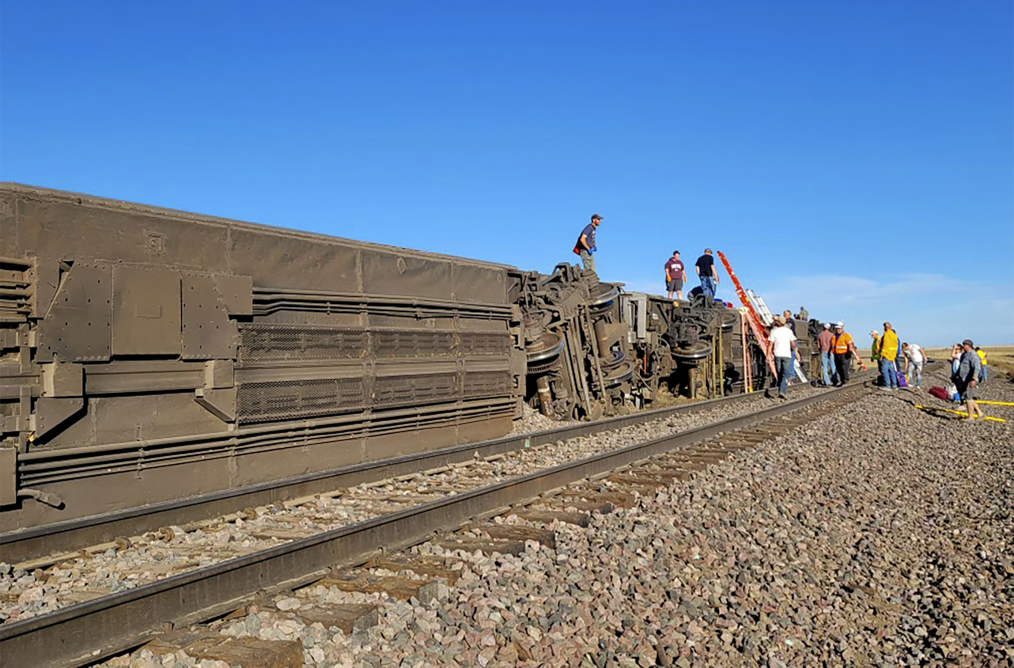 People work at the scene of an Amtrak train derailment in north-central Montana 