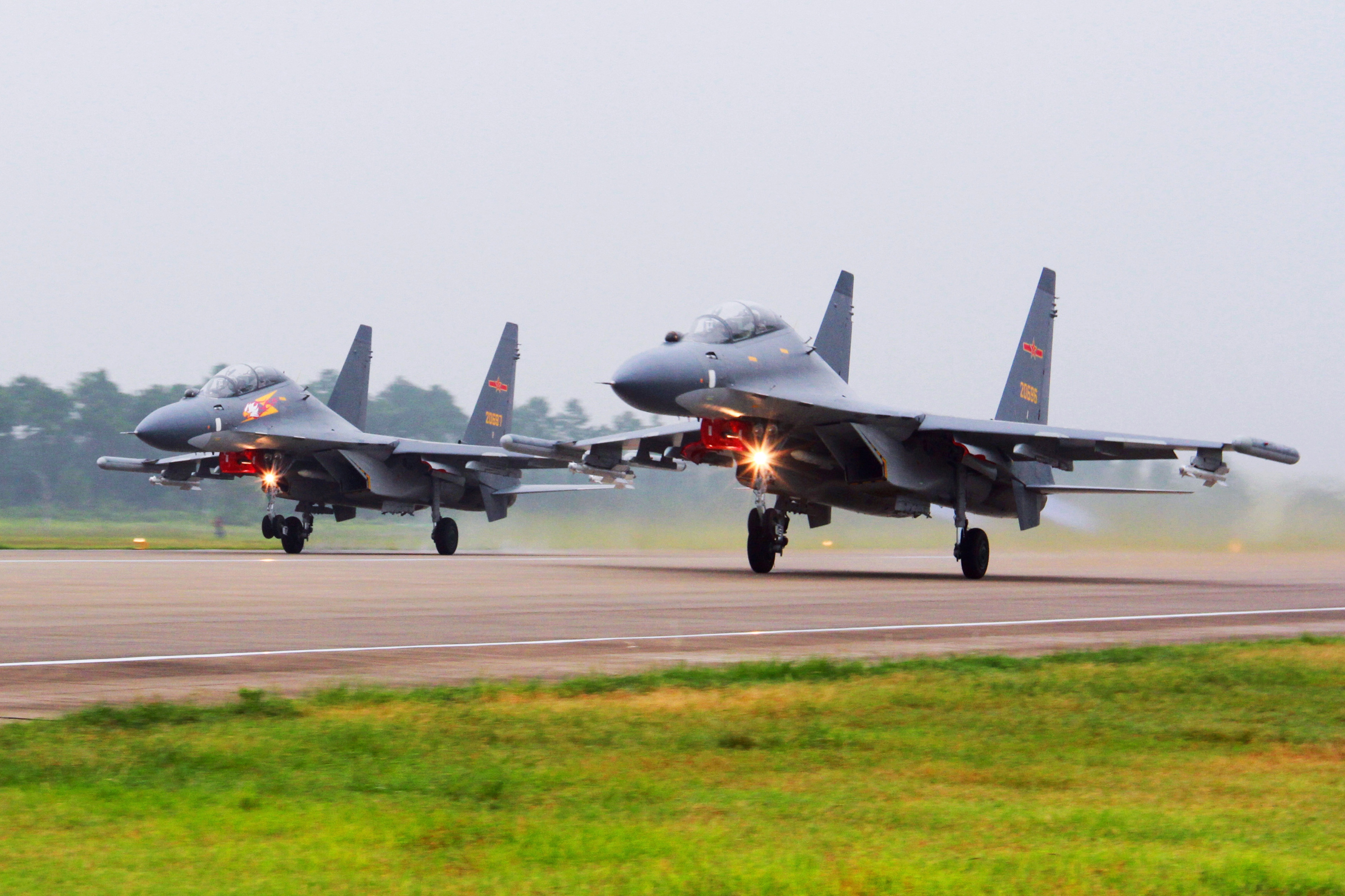 Two Chinese SU-30 fighter jets take off from an unspecified location to fly a patrol over the South China Sea 